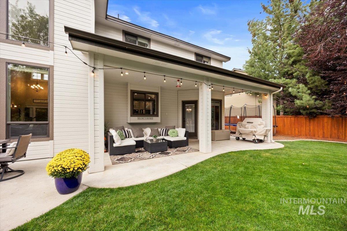 Back of property with an outdoor living space and a patio area