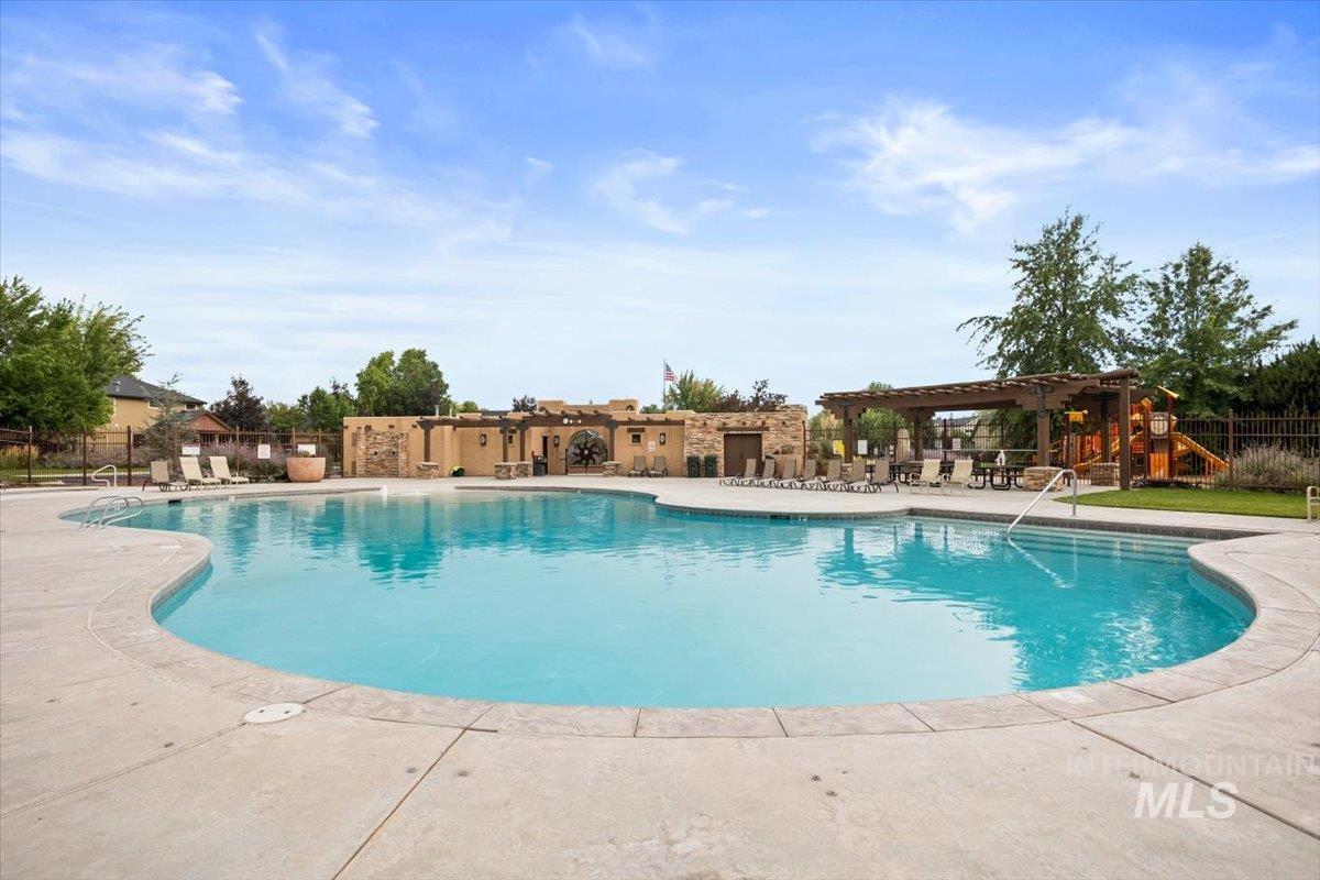 Community pool featuring a patio area and a pergola