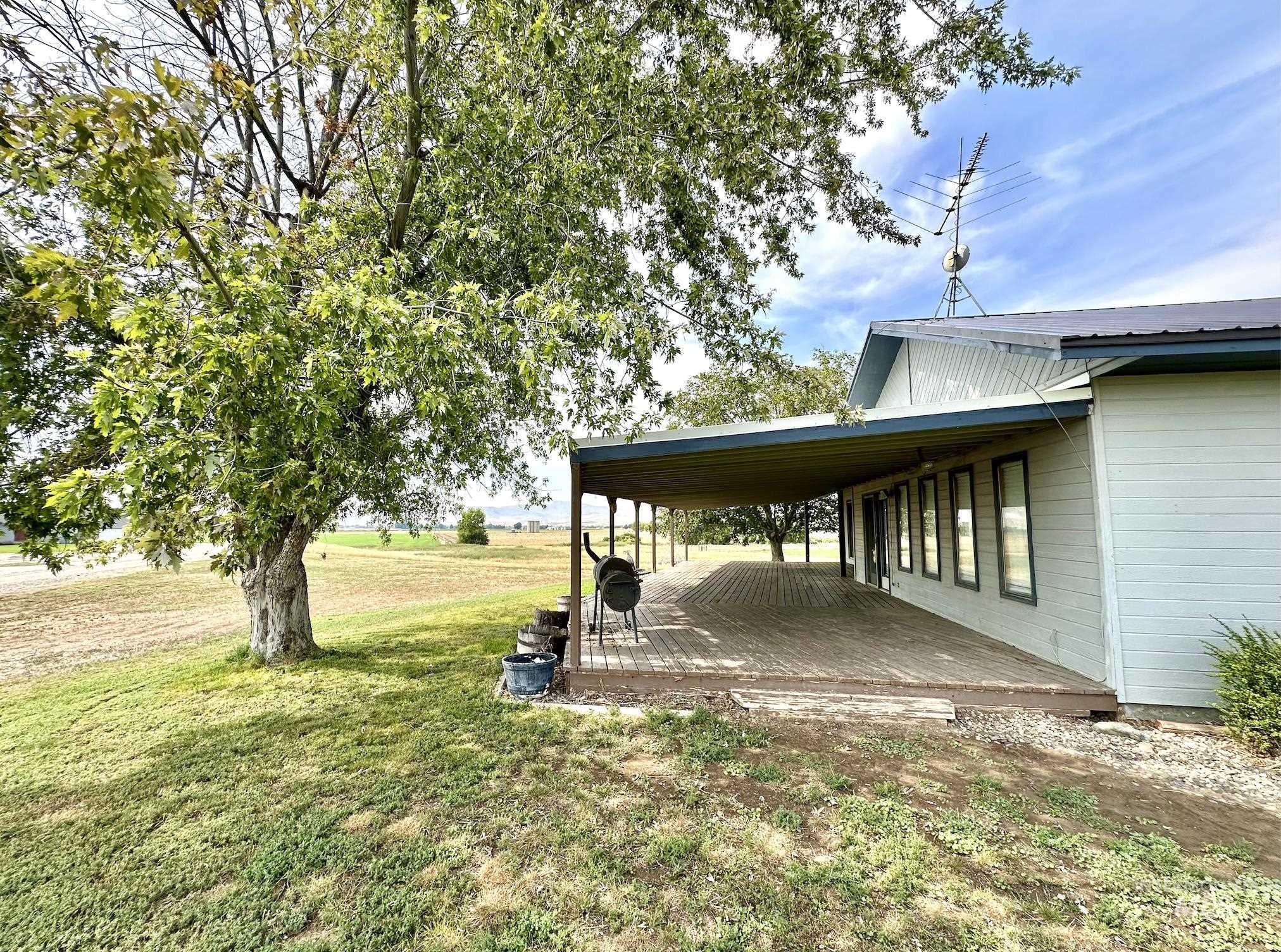 View of green lawn with a wooden deck