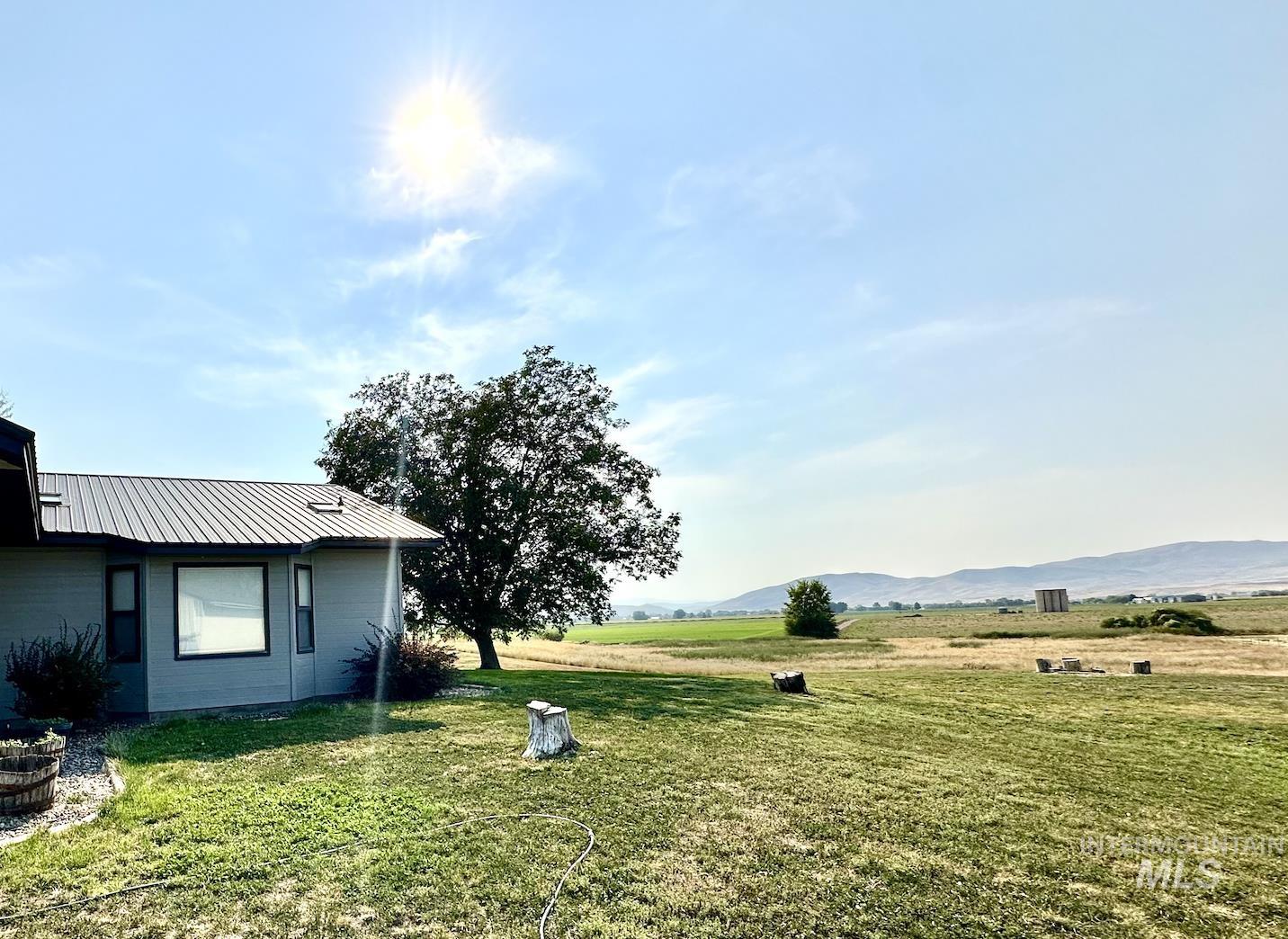 View of green lawn featuring a view of countryside and a mountain view