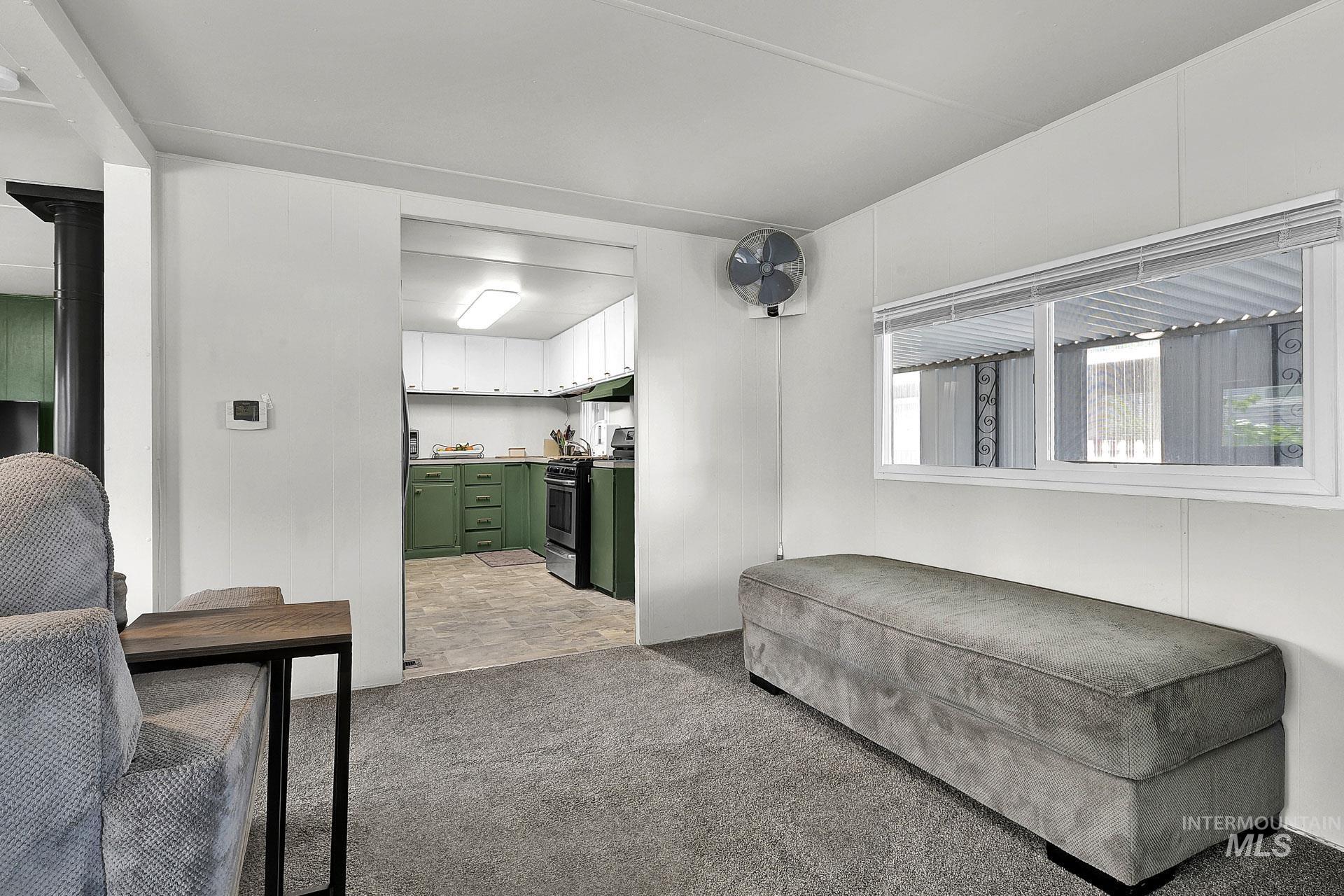 Sitting room featuring light carpet