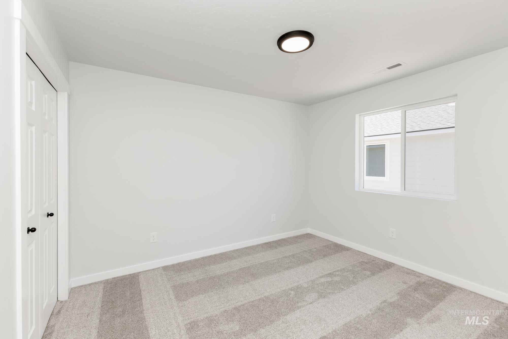 Unfurnished bedroom featuring carpet and a closet