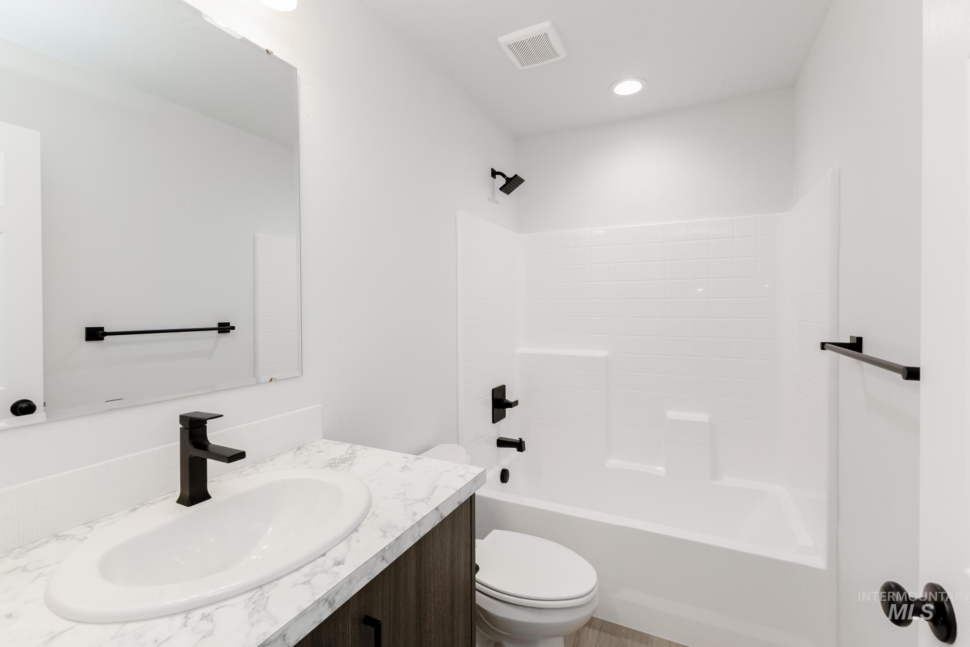 Bathroom with vanity and shower / bath combination