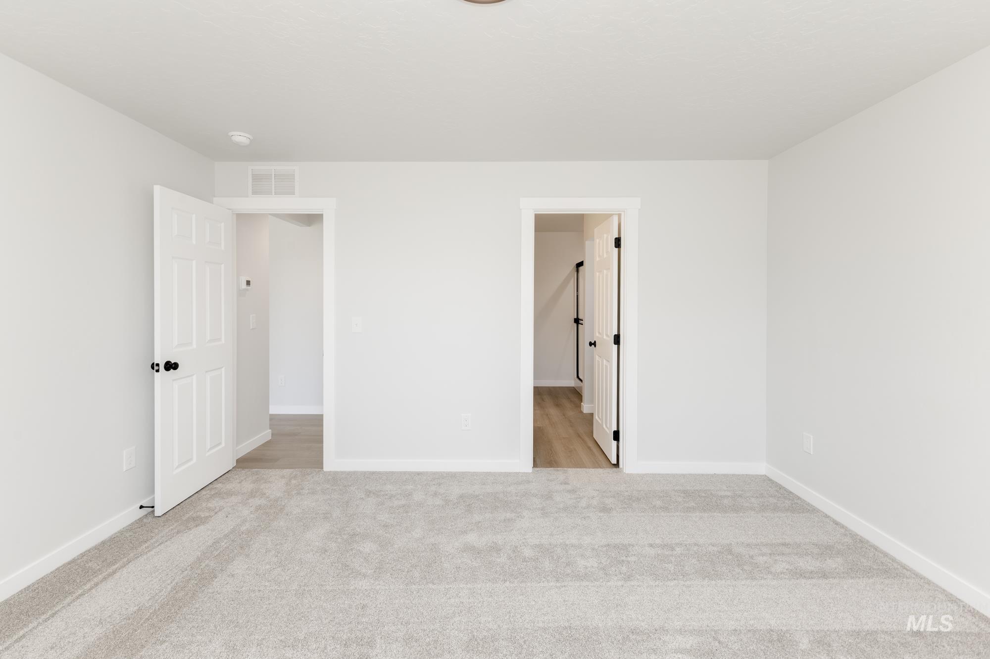 Unfurnished bedroom featuring carpet floors and baseboards