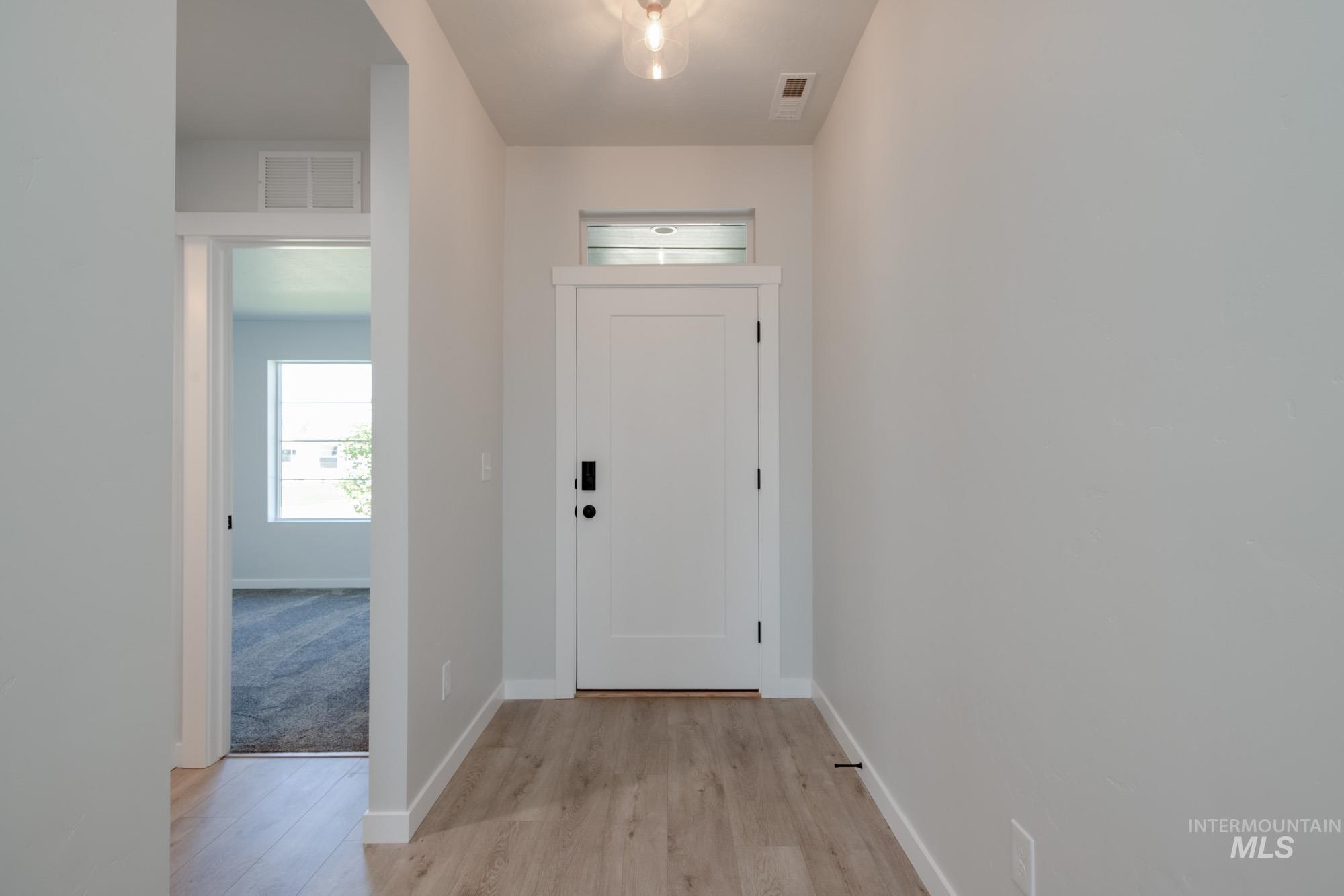 Entryway featuring light wood finished floors and baseboards