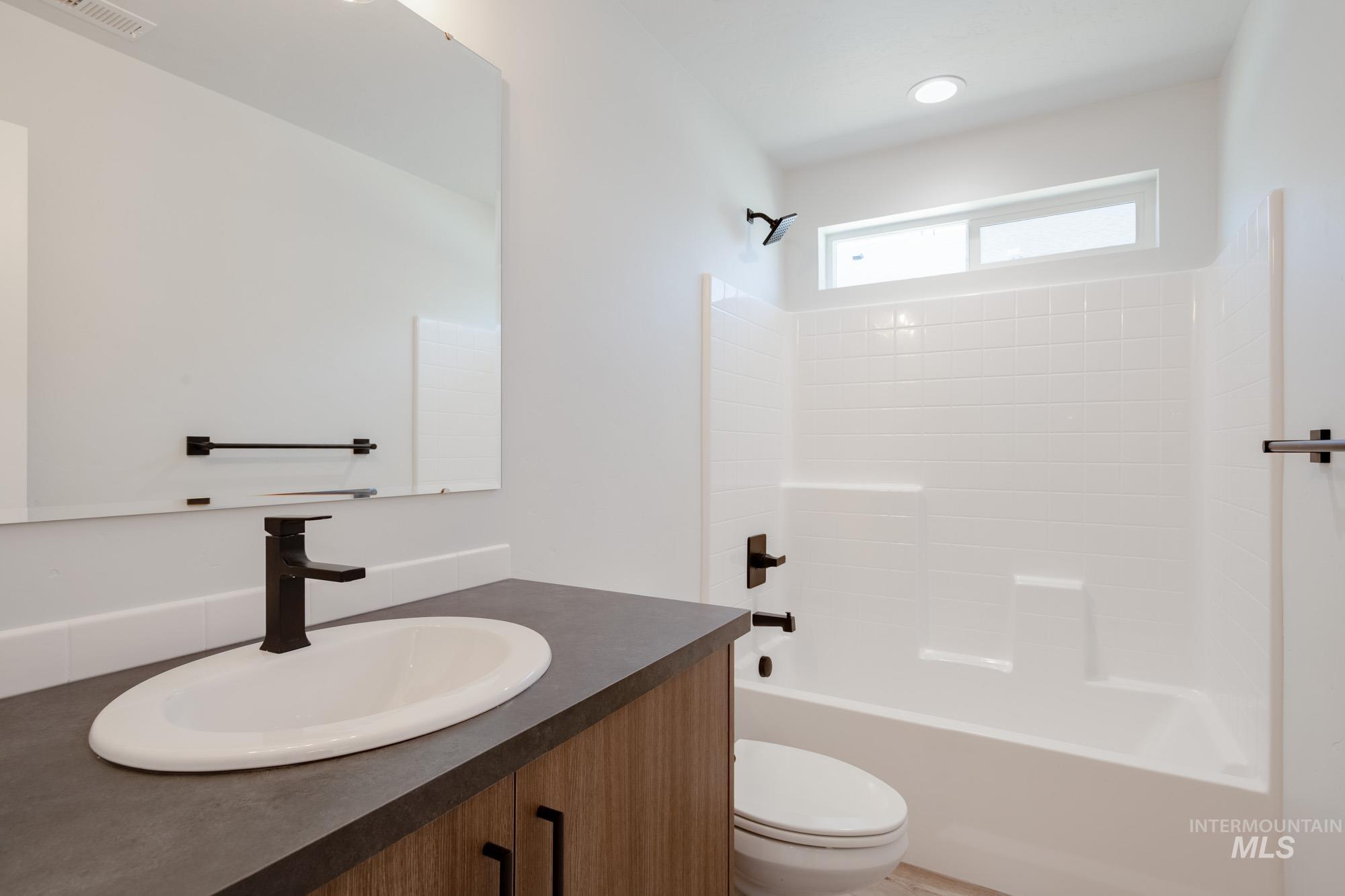 Bathroom with vanity and  shower combination