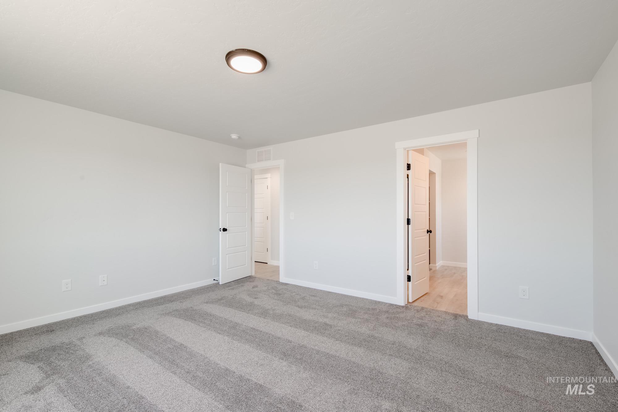 Unfurnished bedroom featuring carpet and baseboards