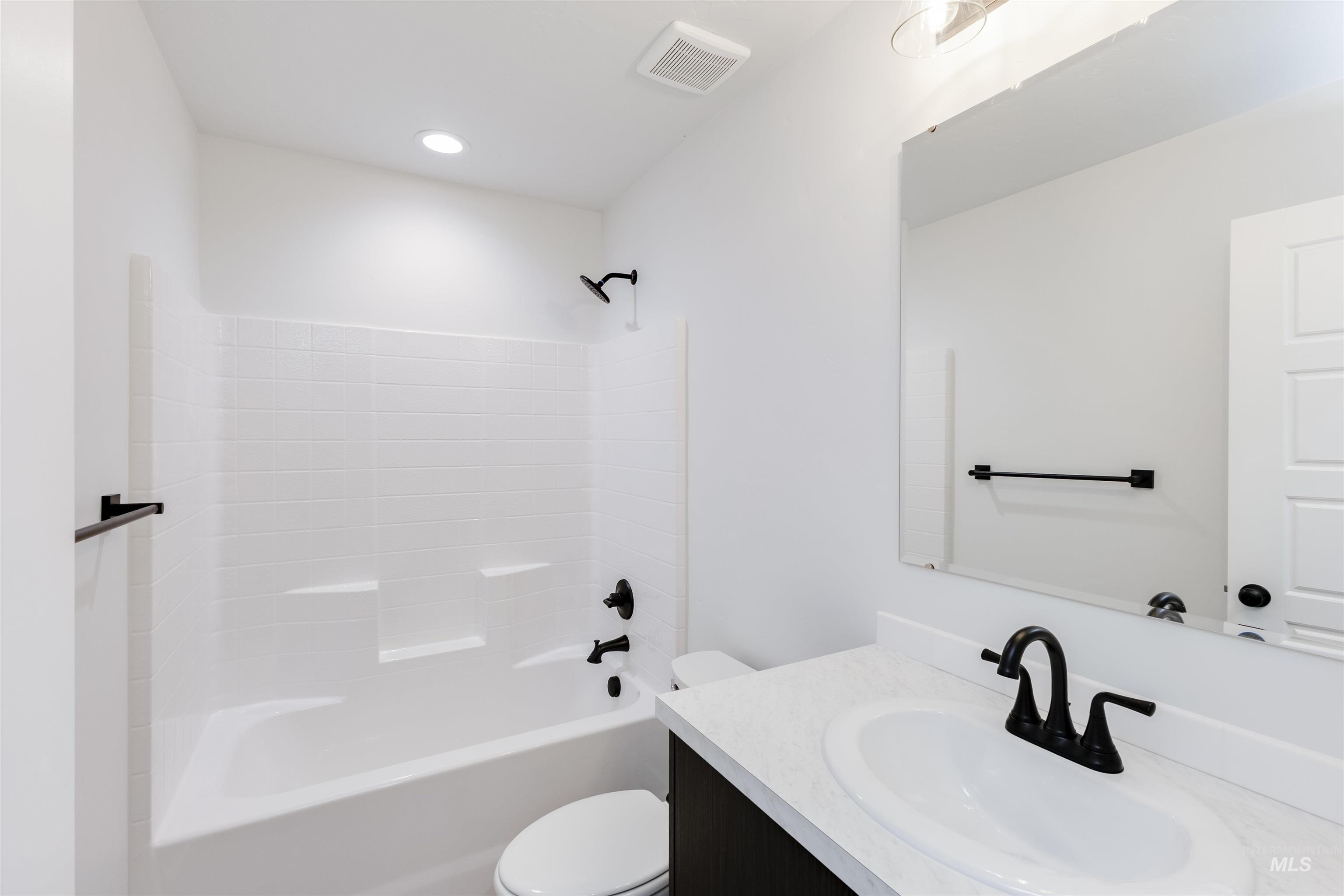Bathroom featuring vanity and bathtub / shower combination