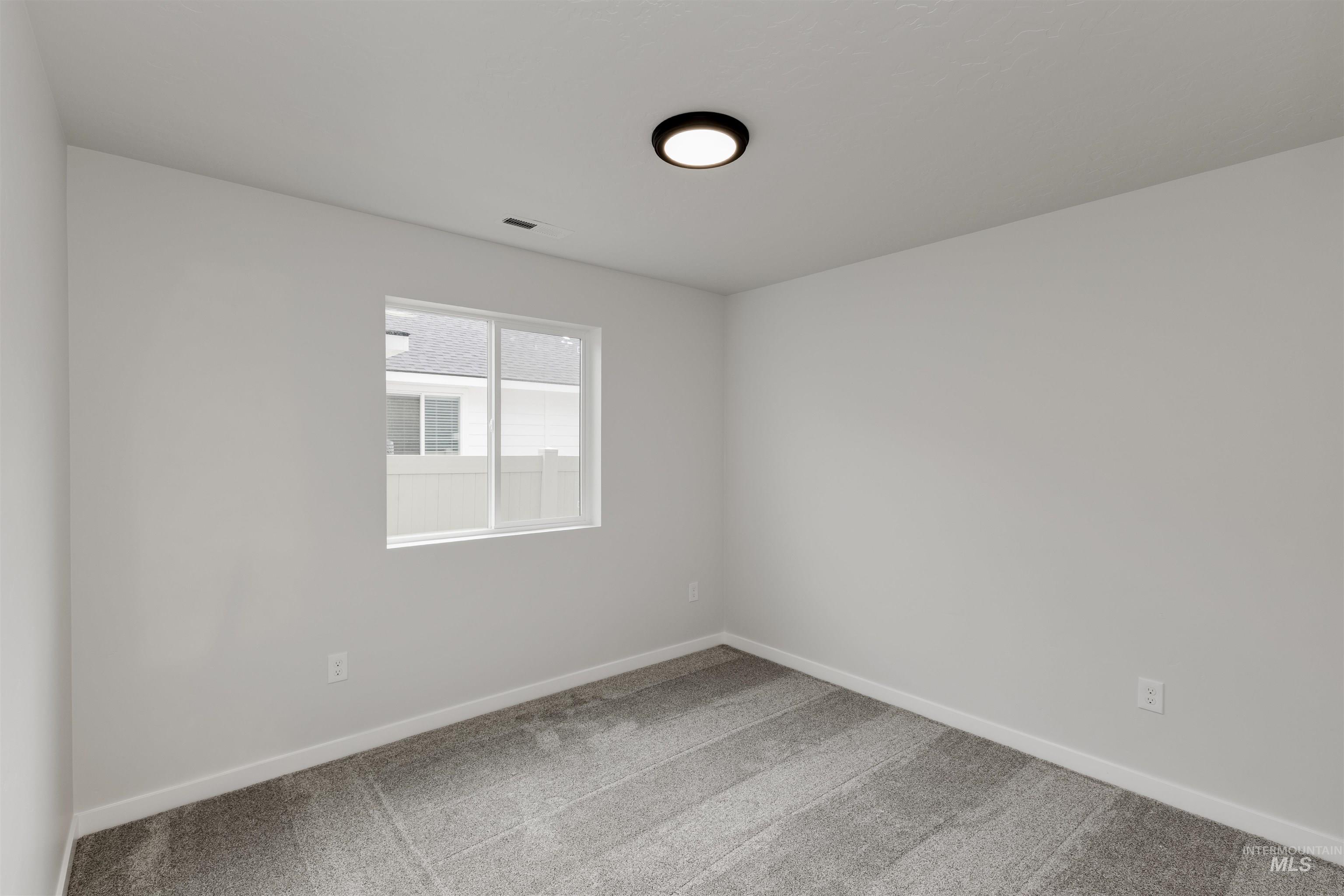 Unfurnished room with baseboards and carpet floors