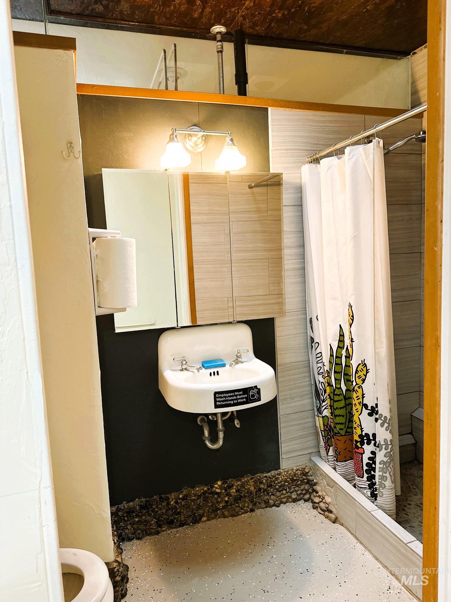 Full bath with a stall shower and toilet