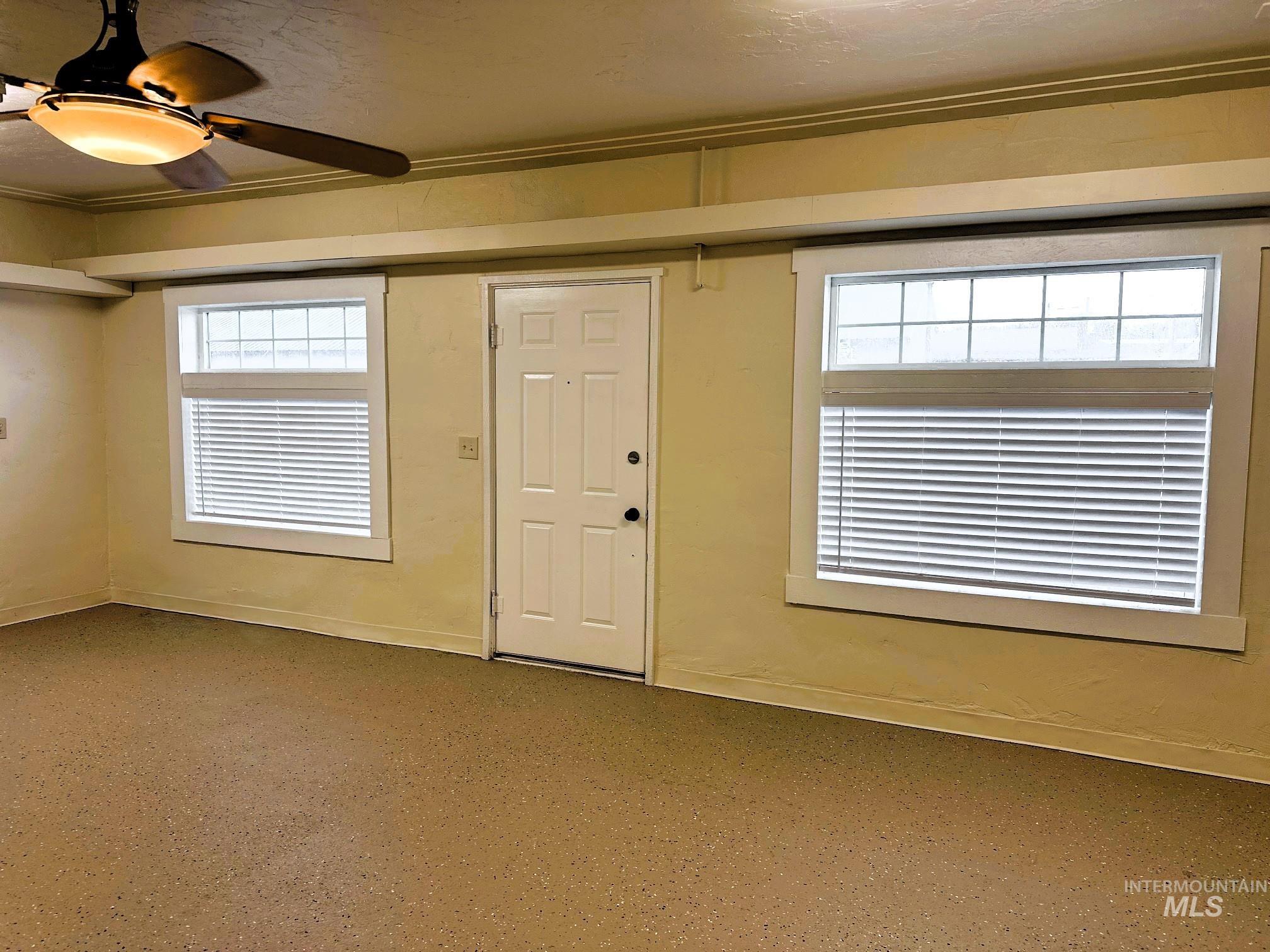 Foyer with plenty of natural light and a ceiling fan
