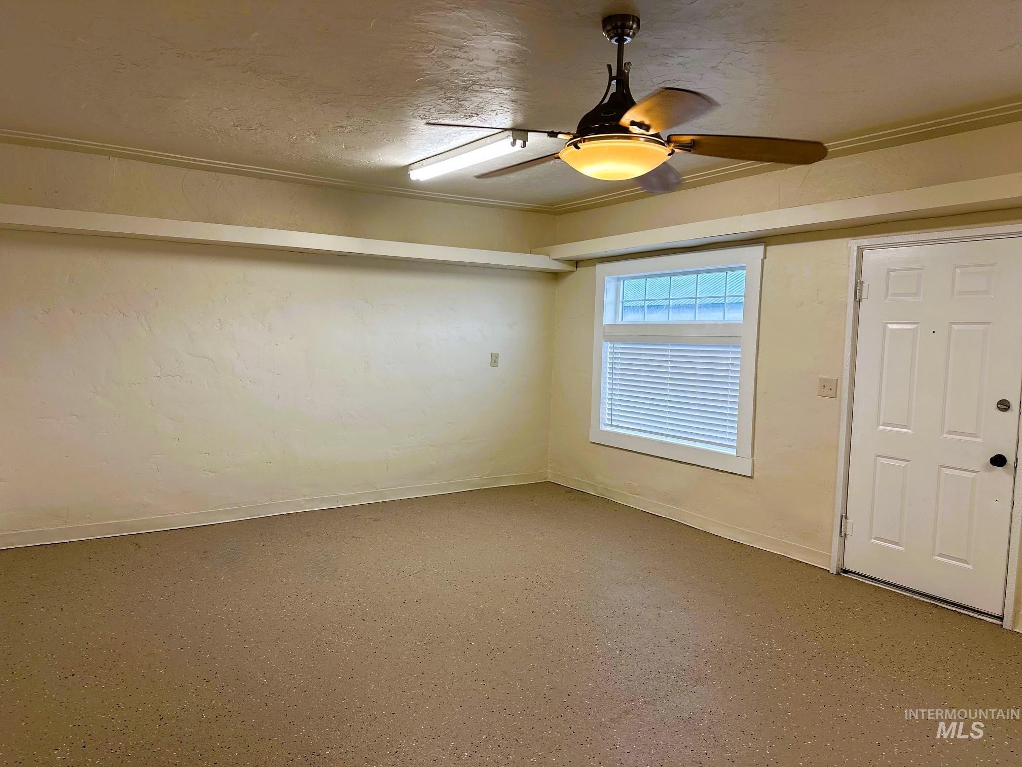 Unfurnished room with ceiling fan, a textured ceiling, and crown molding