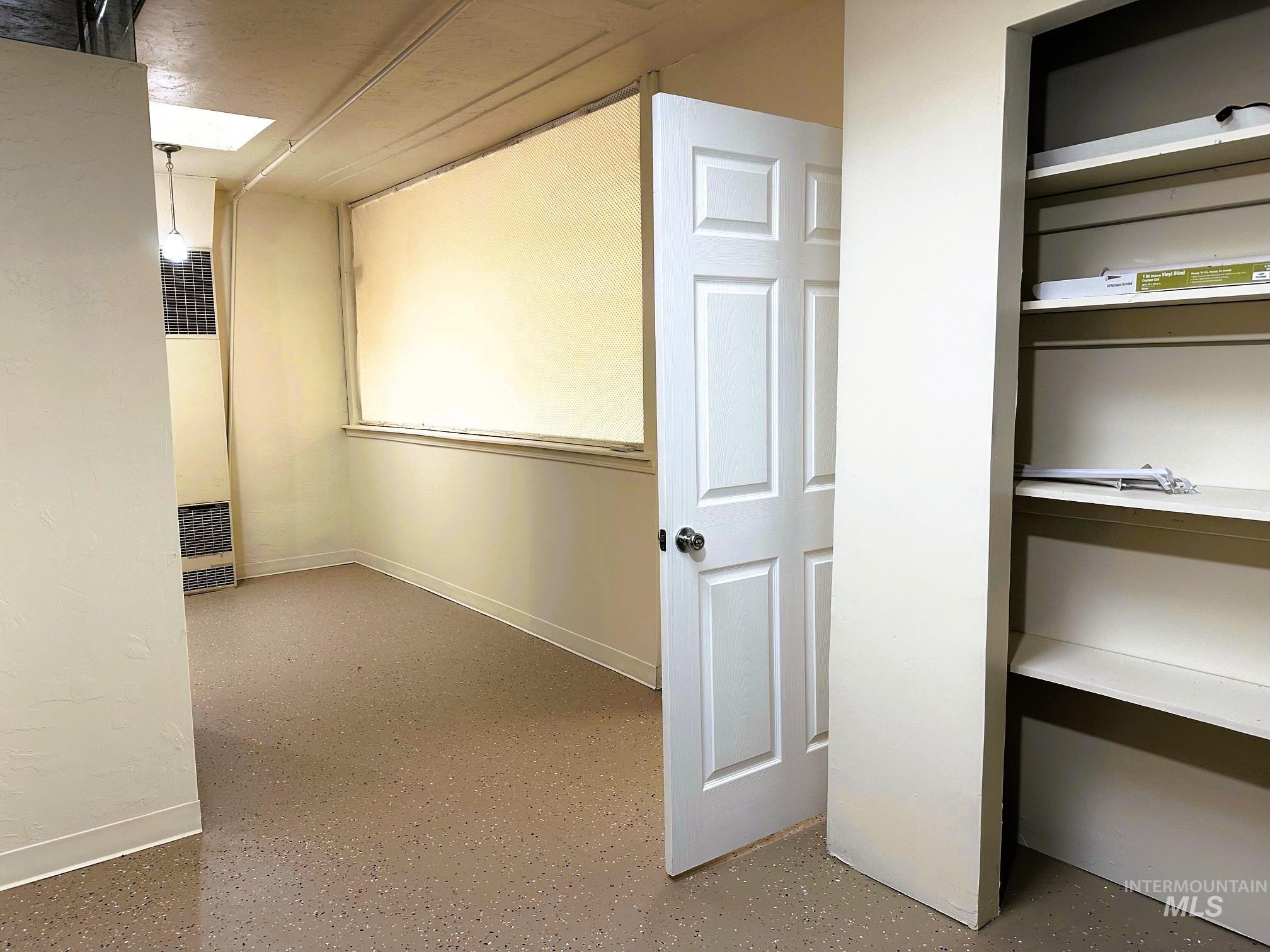 Cinema room with a heating unit and baseboards