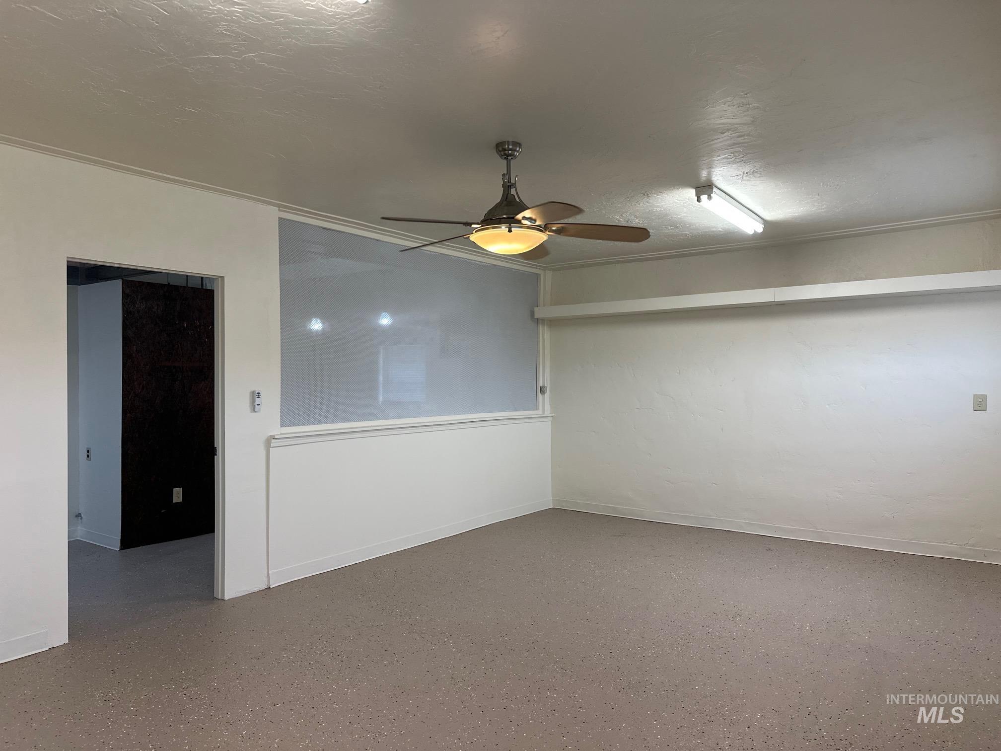 Spare room featuring ceiling fan and a textured ceiling