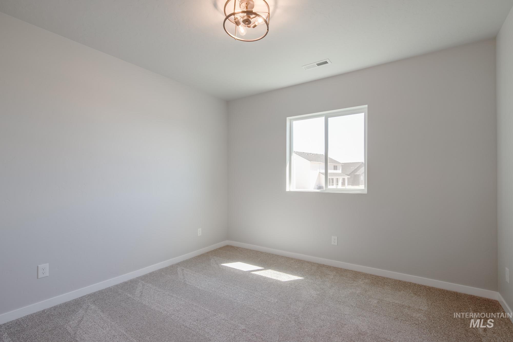 Empty room with carpet and baseboards