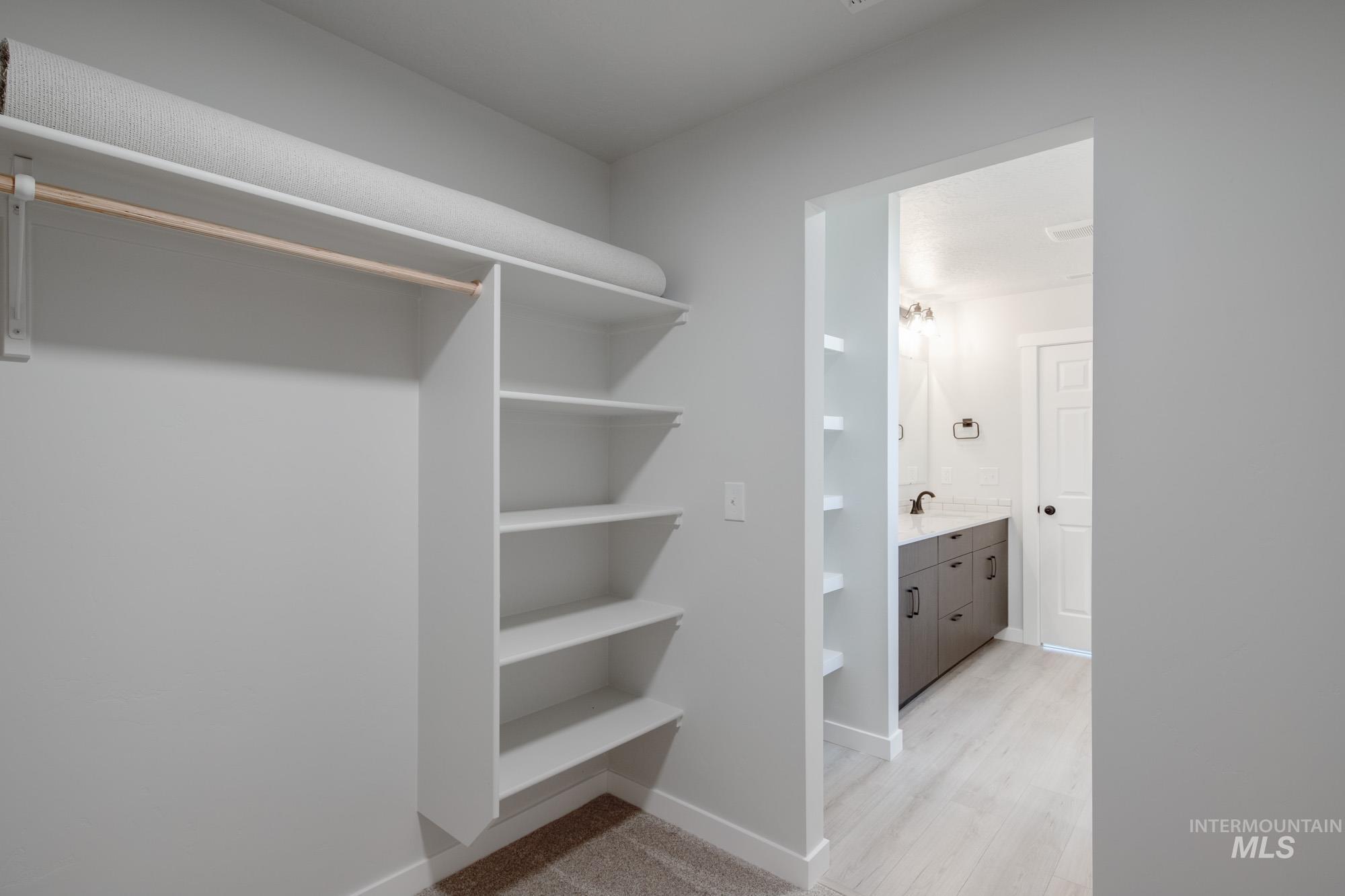 Walk in closet featuring light wood-type flooring