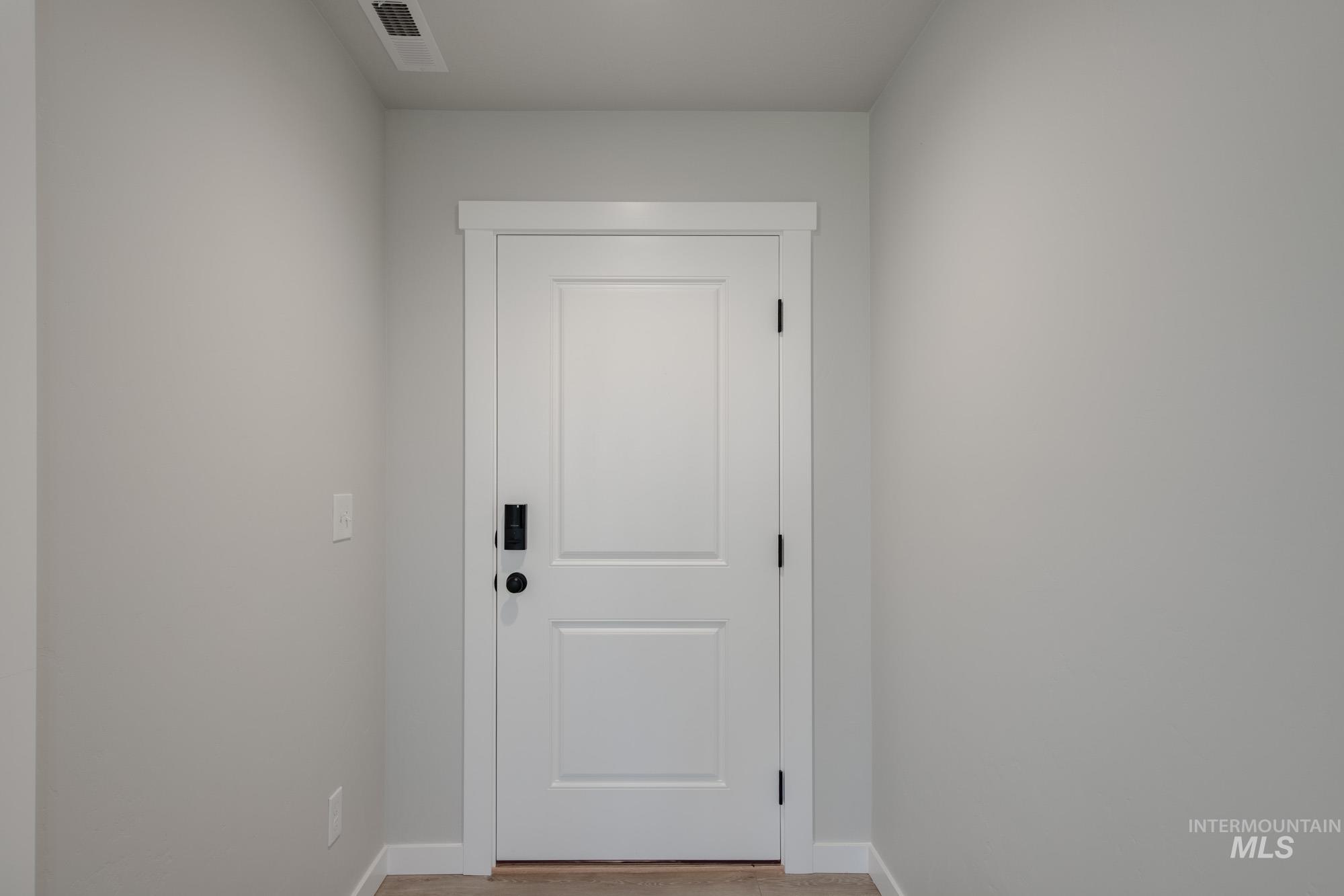 Entryway with baseboards and wood finished floors