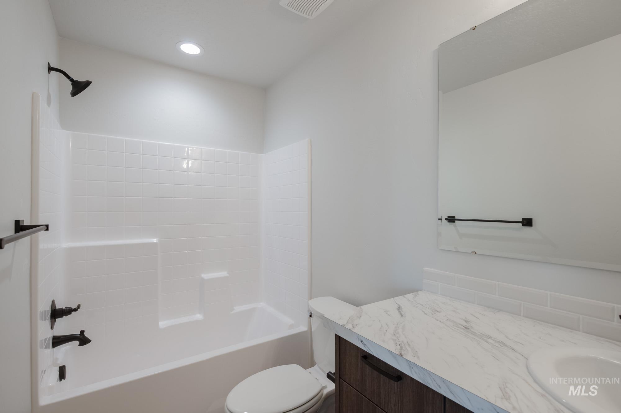 Full bath featuring vanity, shower / washtub combination, and recessed lighting