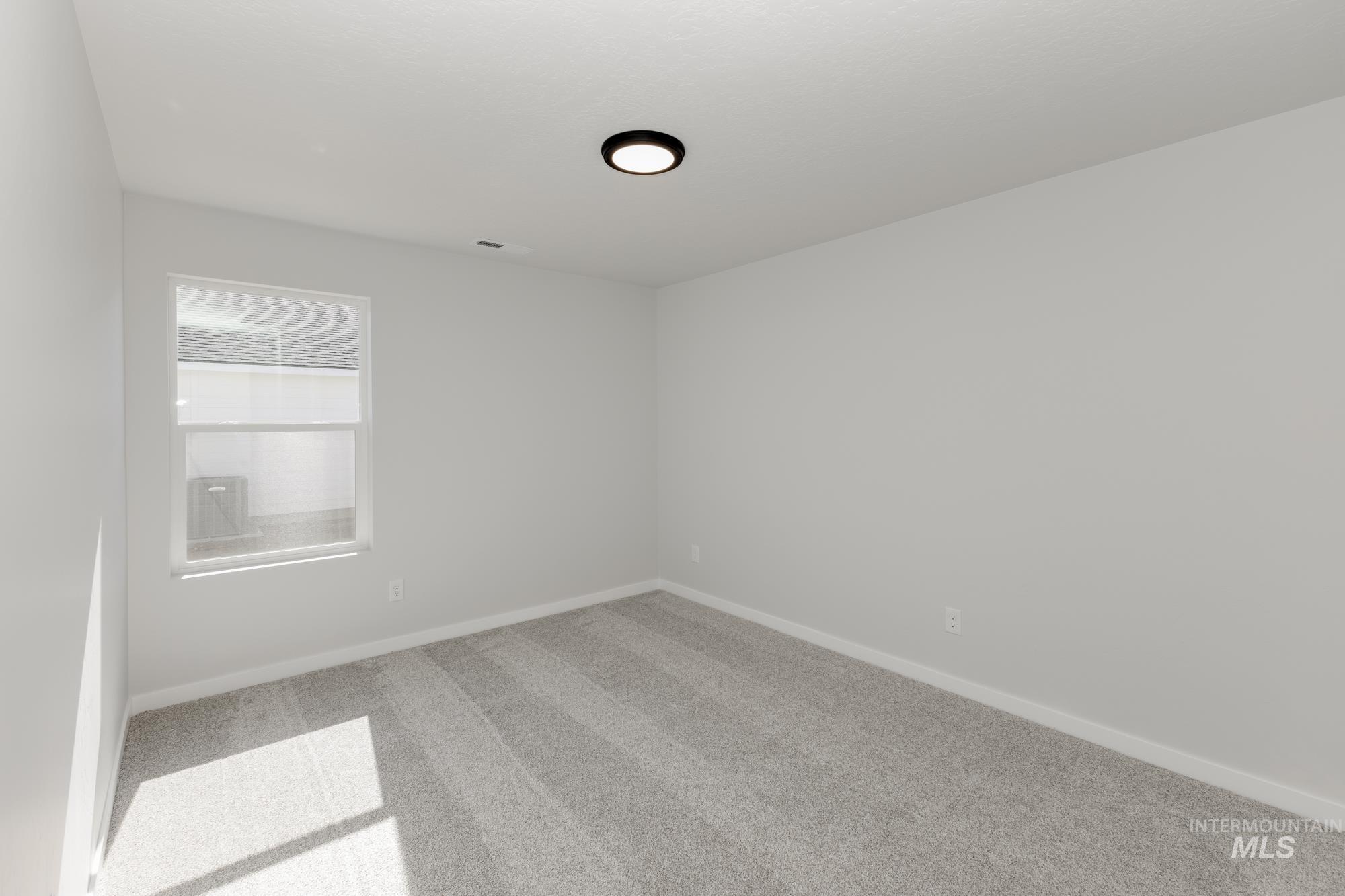 Unfurnished room with carpet floors and baseboards