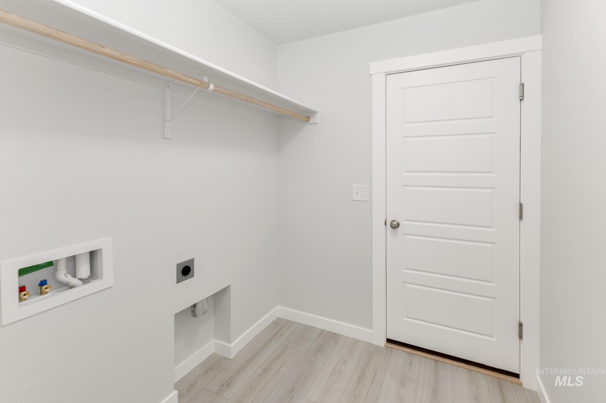 Laundry area featuring washer hookup, electric dryer hookup, and light wood-style floors