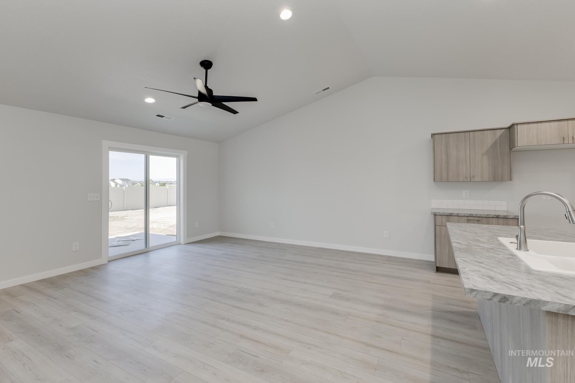 Unfurnished living room featuring recessed lighting, light wood-type flooring, lofted ceiling, and ceiling fan