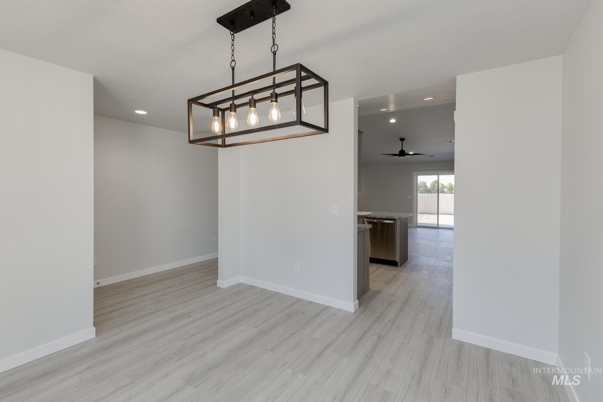 Unfurnished dining area featuring ceiling fan, recessed lighting, and light wood finished floors