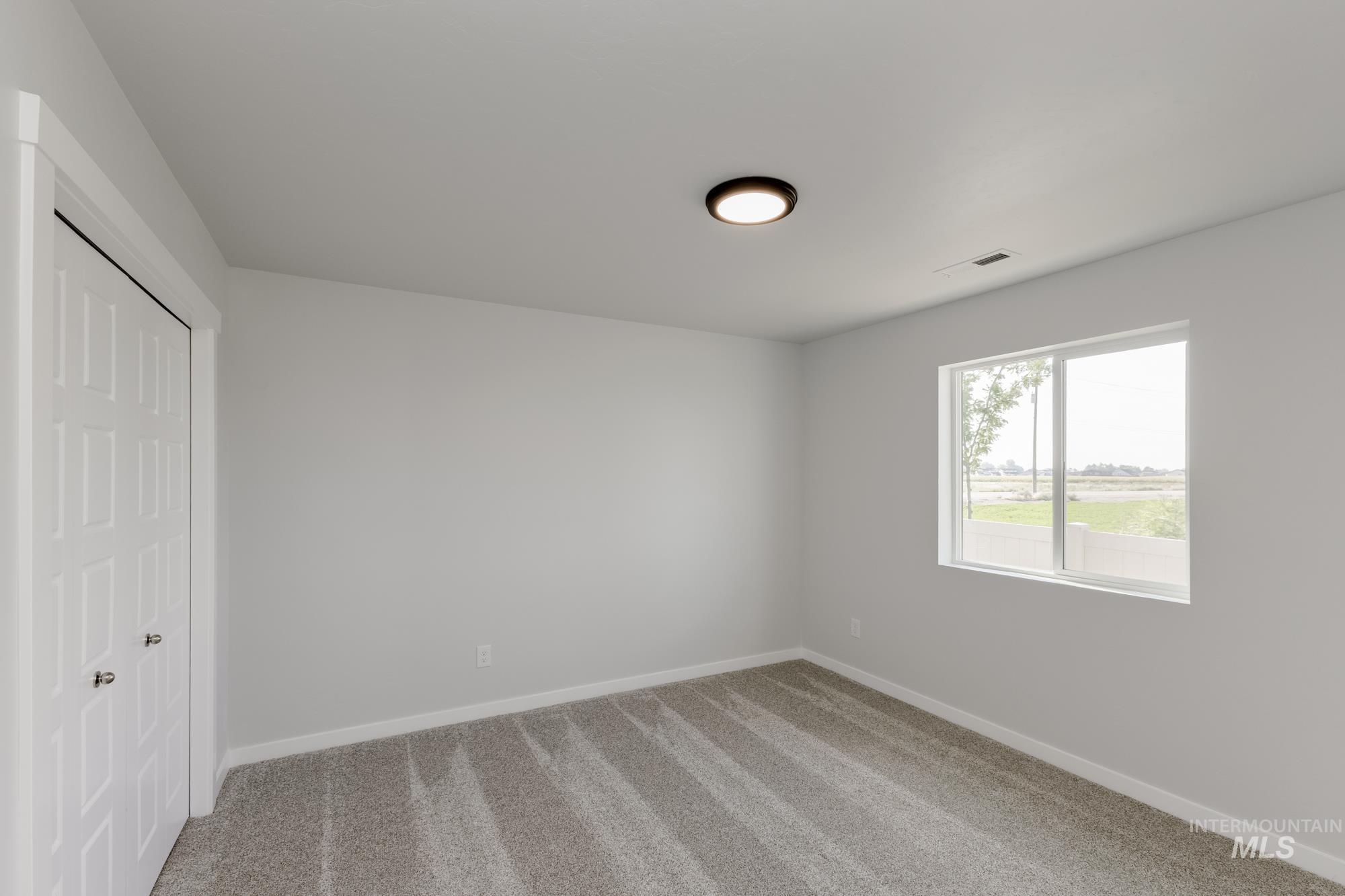Unfurnished bedroom with carpet floors and a closet