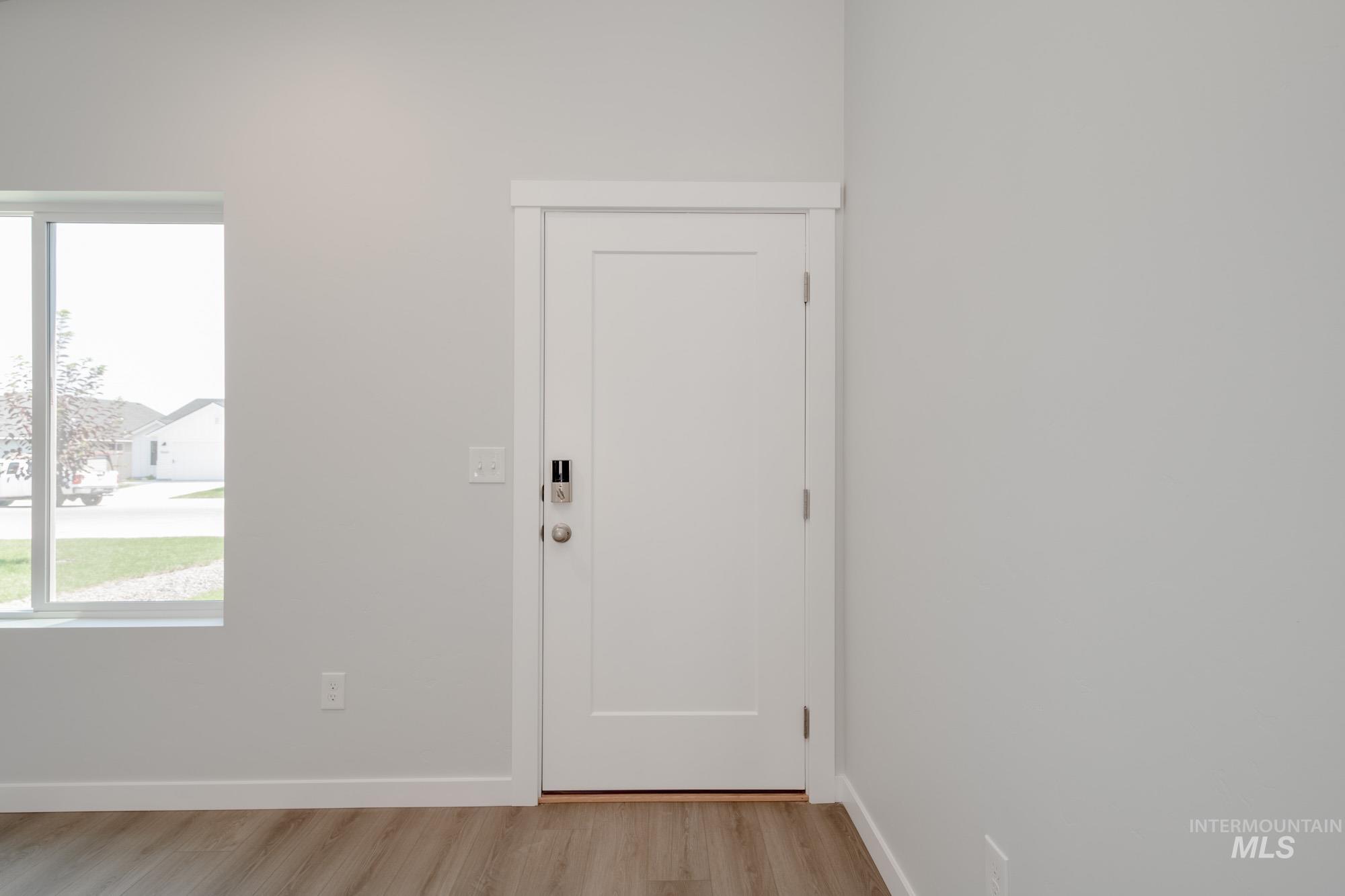 Foyer featuring baseboards and light wood finished floors