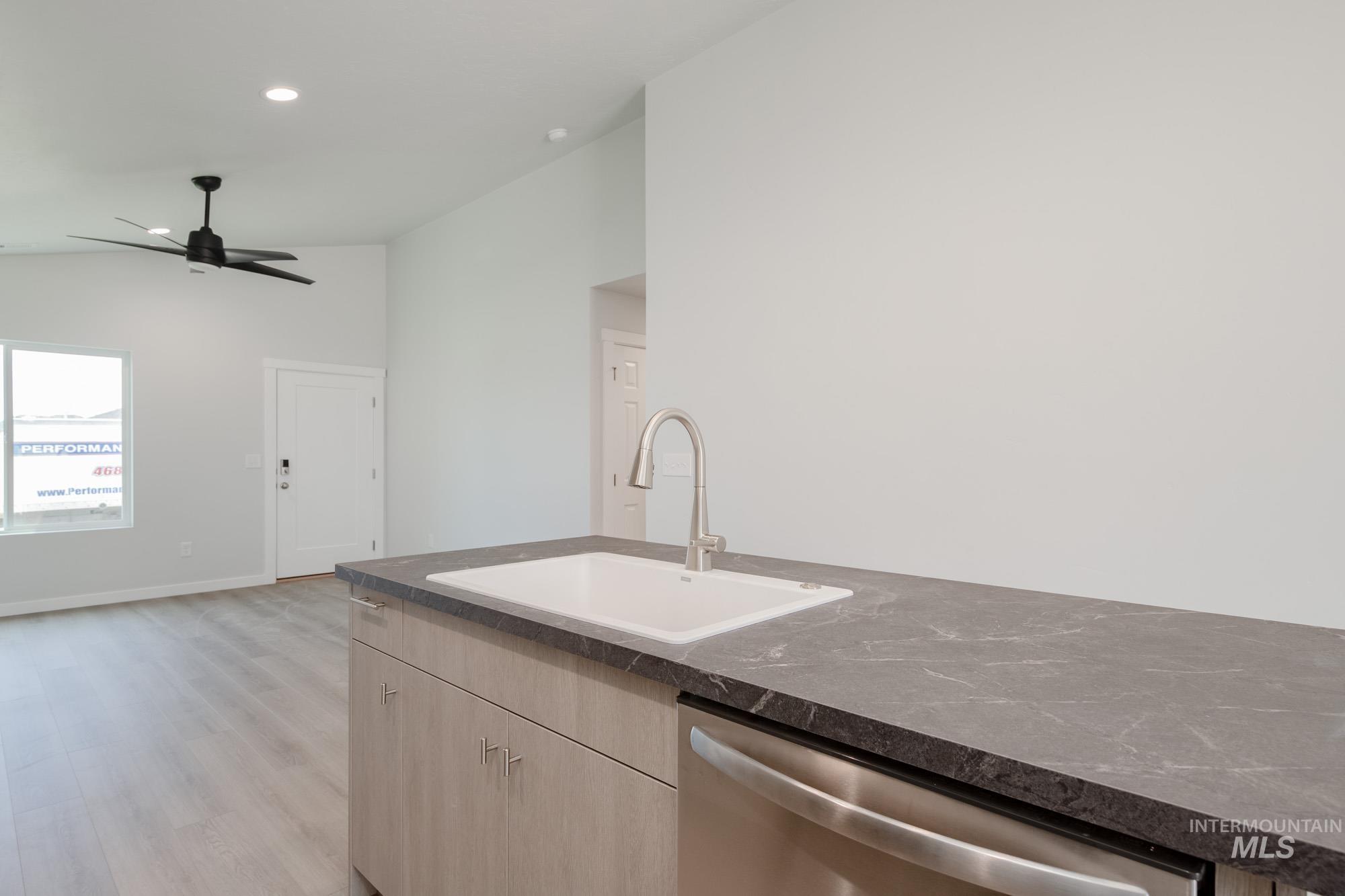Kitchen with dishwasher, light wood-style flooring, light brown cabinetry, recessed lighting, and a ceiling fan