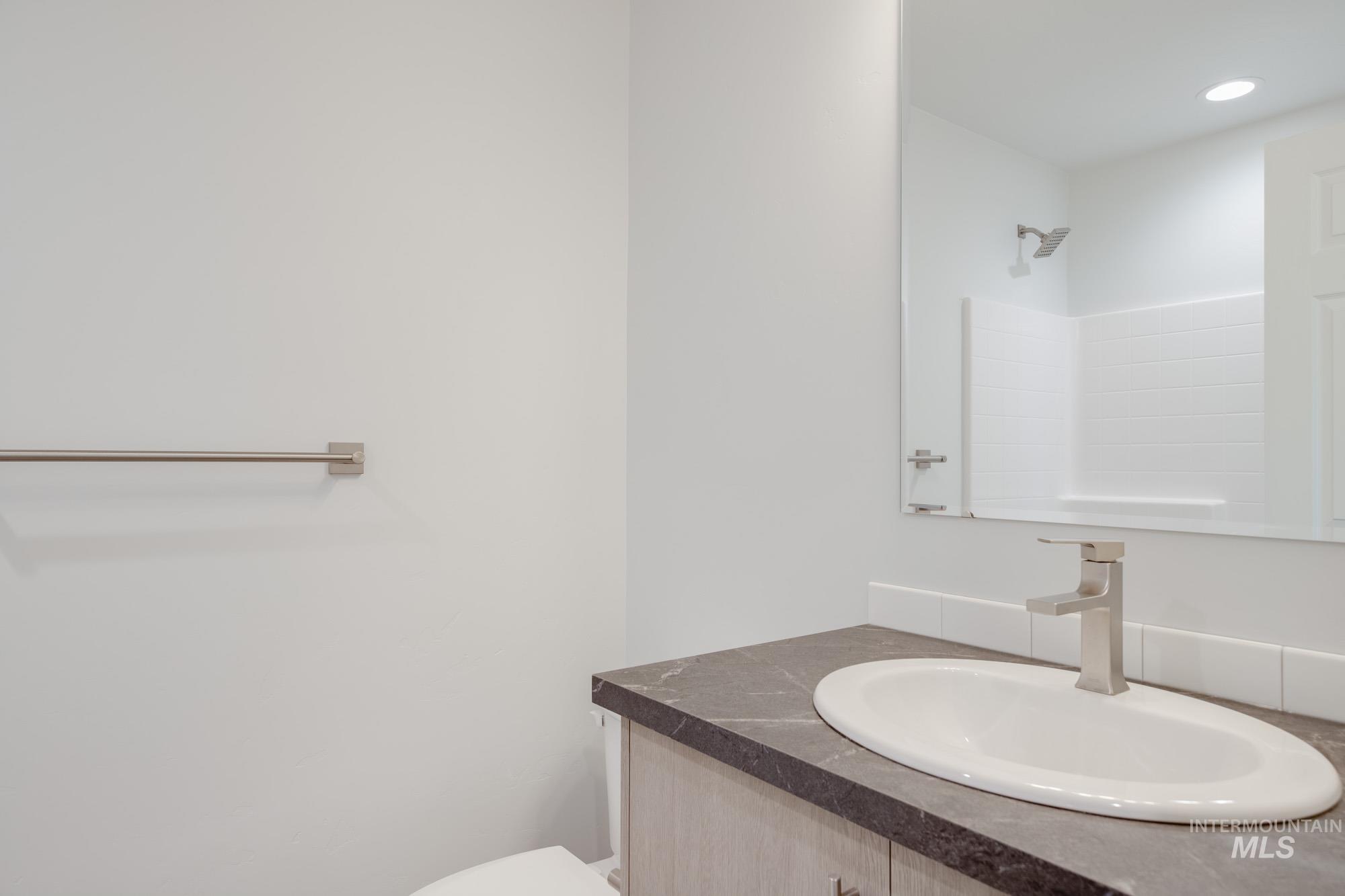 Bathroom featuring vanity and recessed lighting