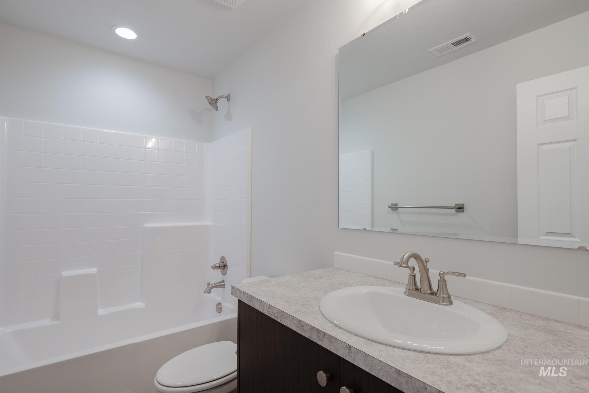 Bathroom featuring vanity and bathing tub / shower combination