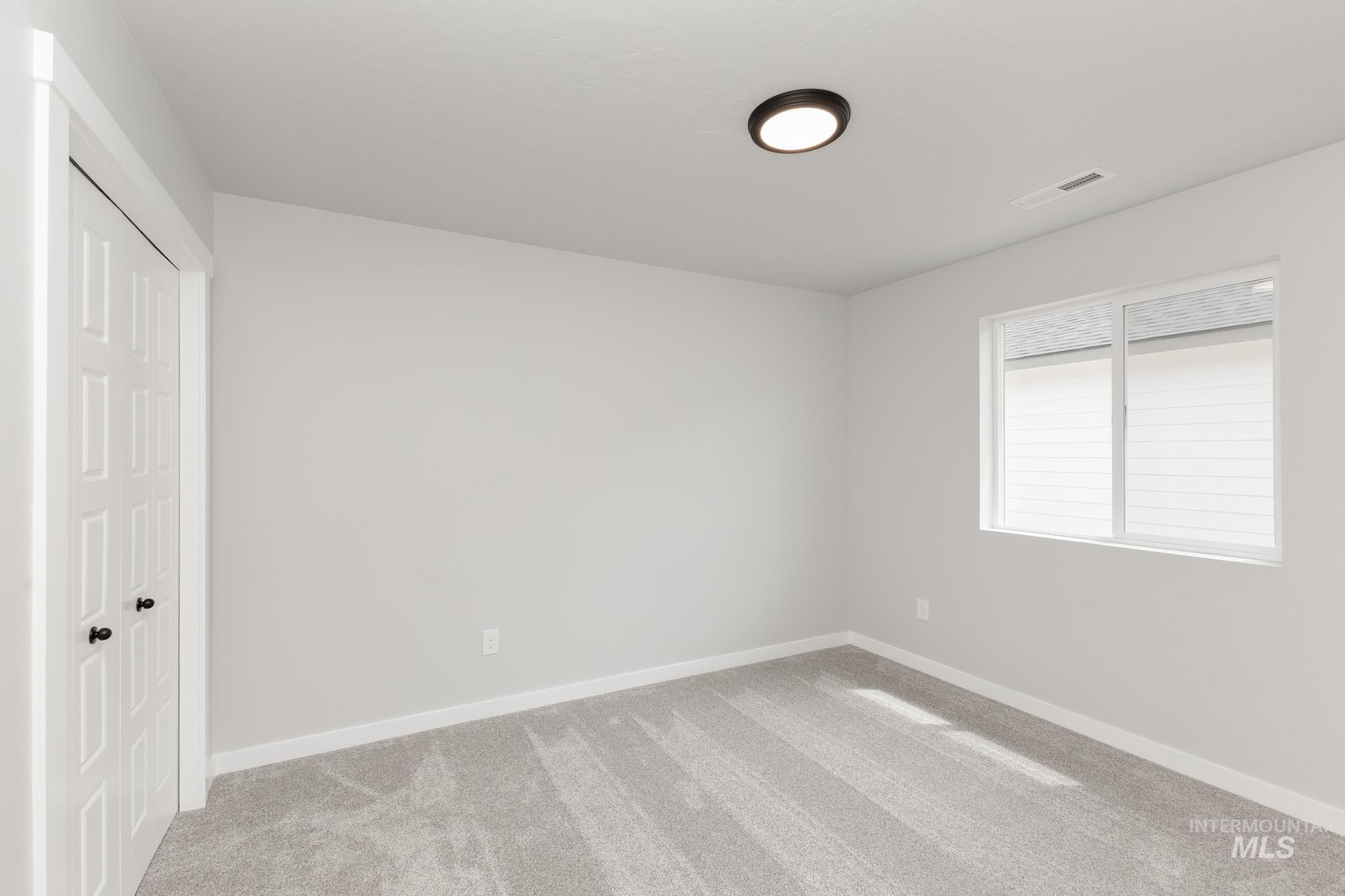 Unfurnished bedroom featuring carpet floors and baseboards