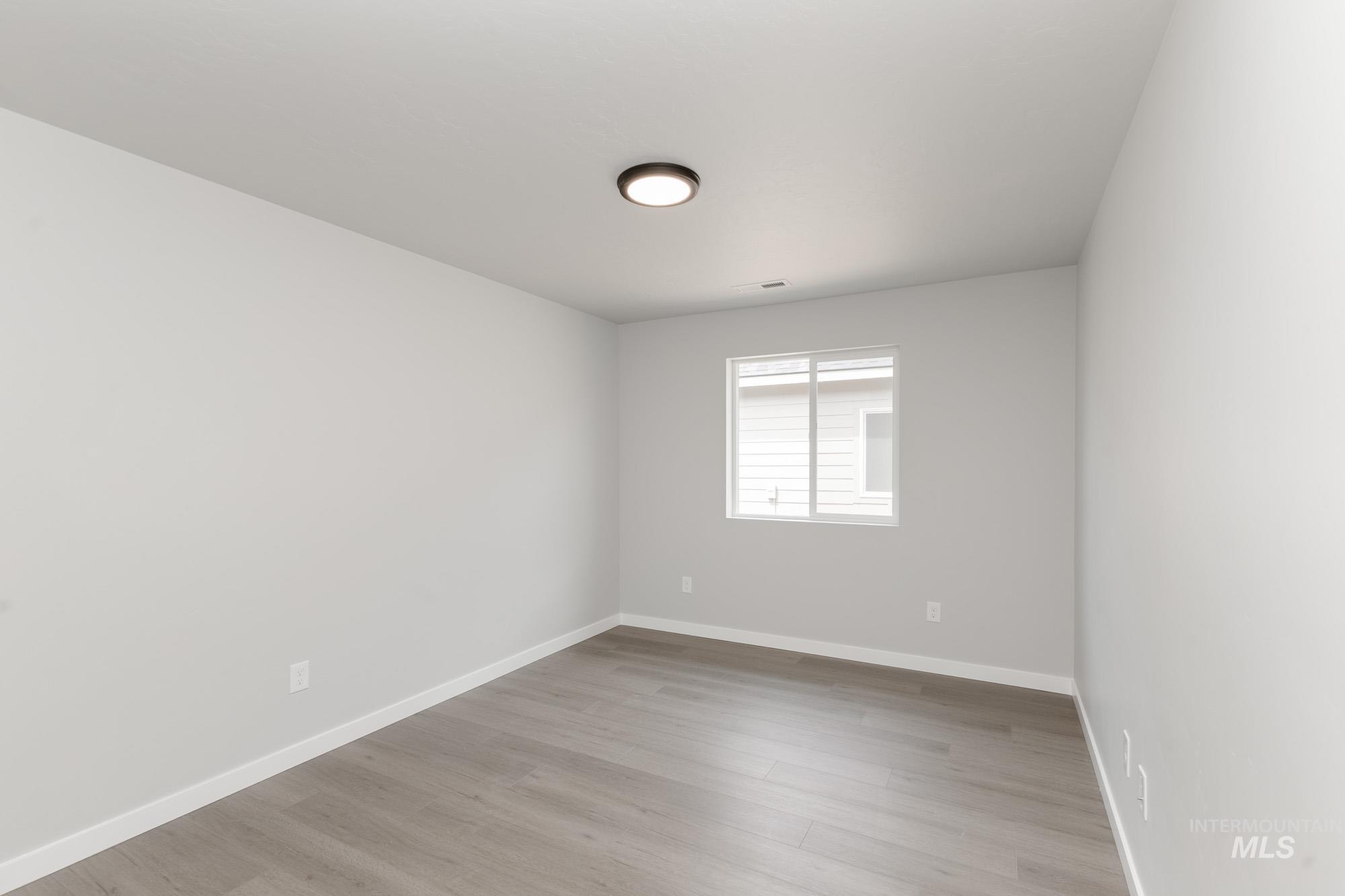 Empty room featuring light wood-style floors and baseboards