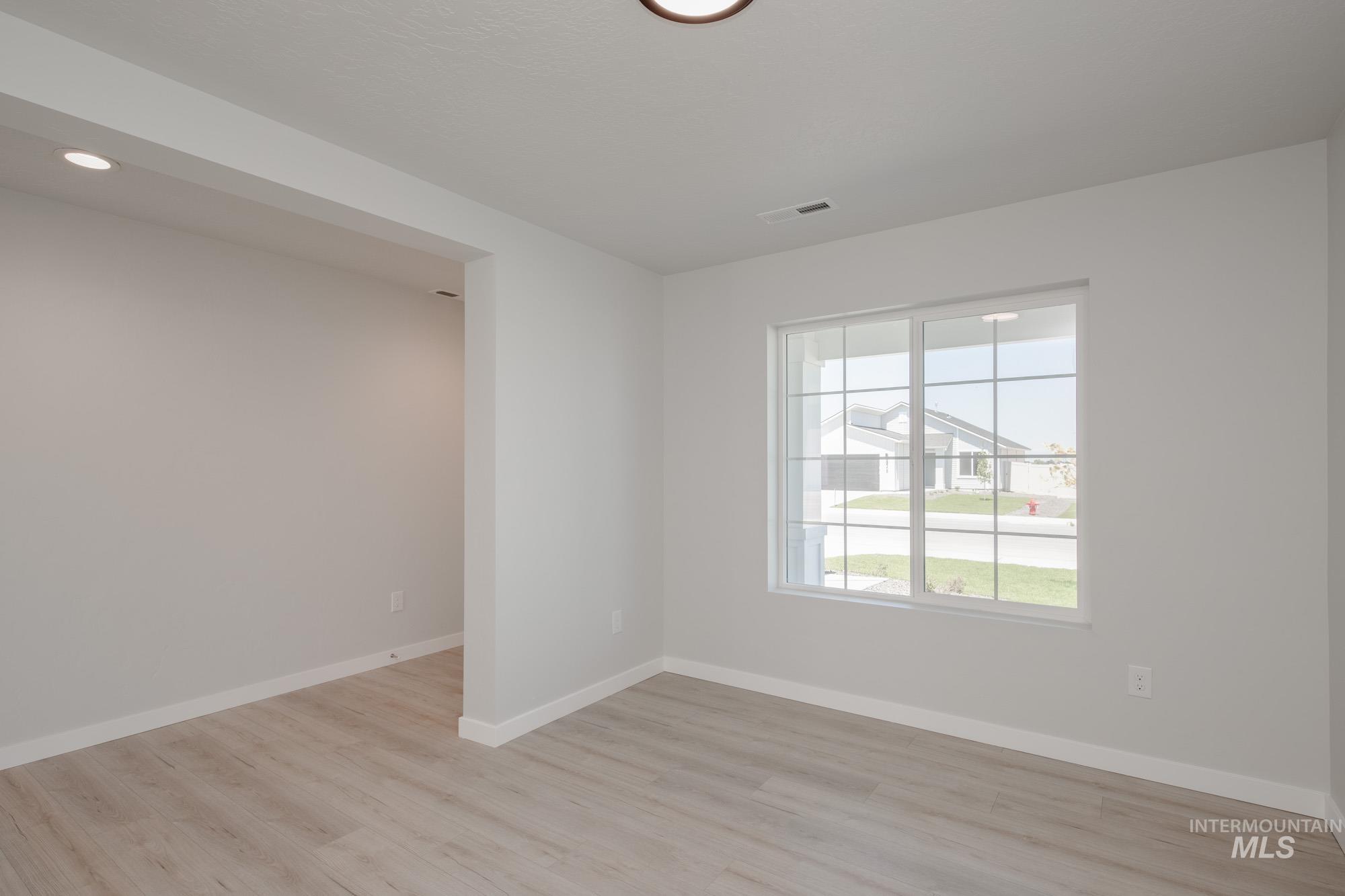 Unfurnished room featuring light wood finished floors and recessed lighting