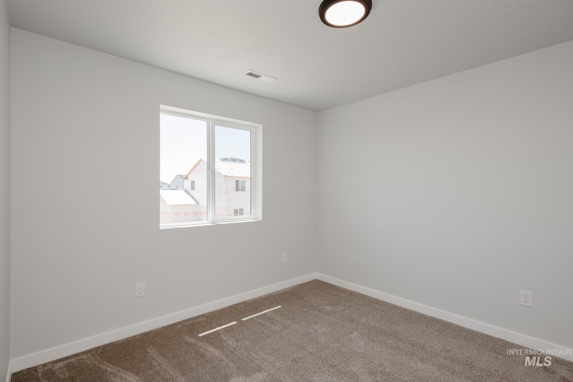 Unfurnished room with carpet flooring and baseboards
