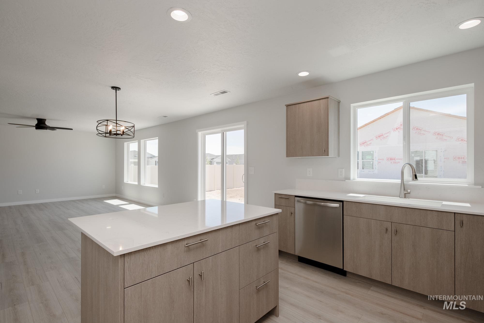 Kitchen featuring light brown cabinetry, light wood-style floors, healthy amount of natural light, and recessed lighting