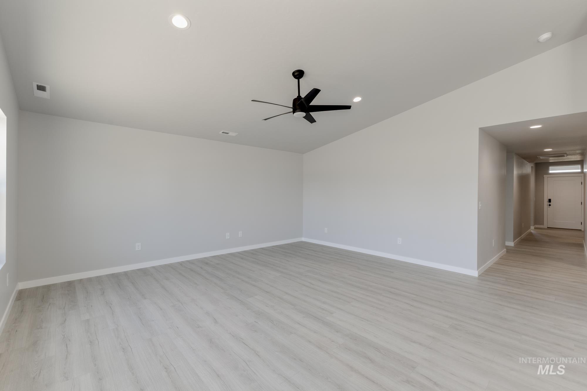 Empty room with light wood finished floors, recessed lighting, and a ceiling fan