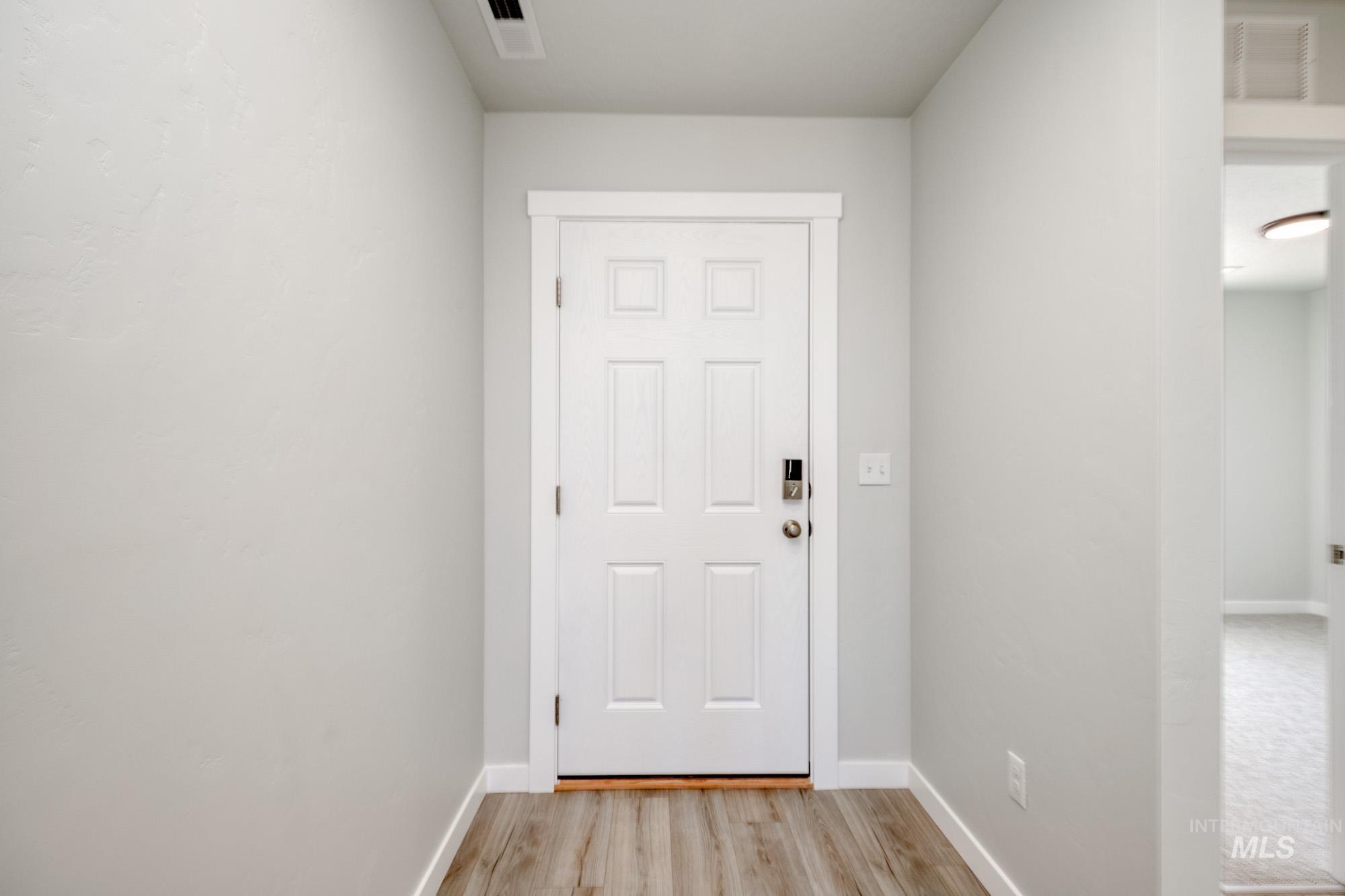 Entryway featuring baseboards and wood finished floors