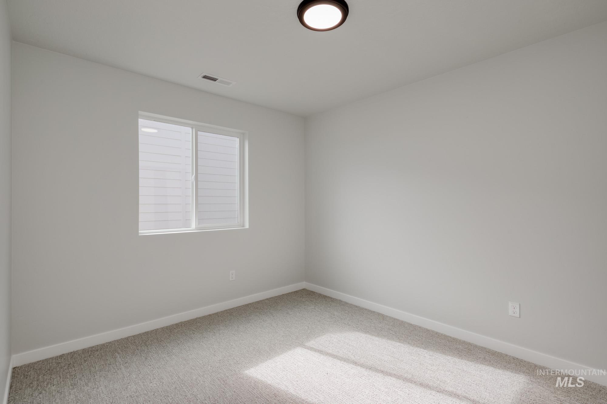 Empty room with carpet and baseboards