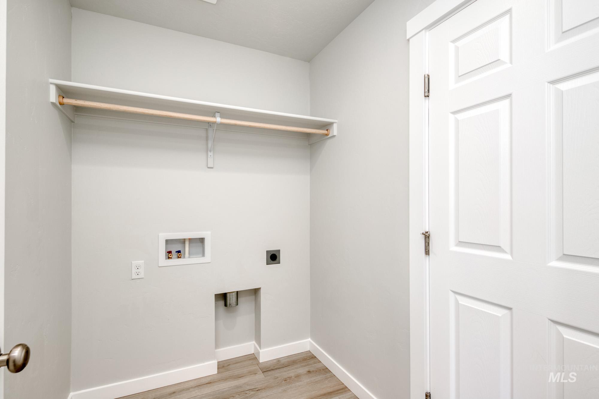 Laundry area featuring light wood-type flooring, electric dryer hookup, and hookup for a washing machine