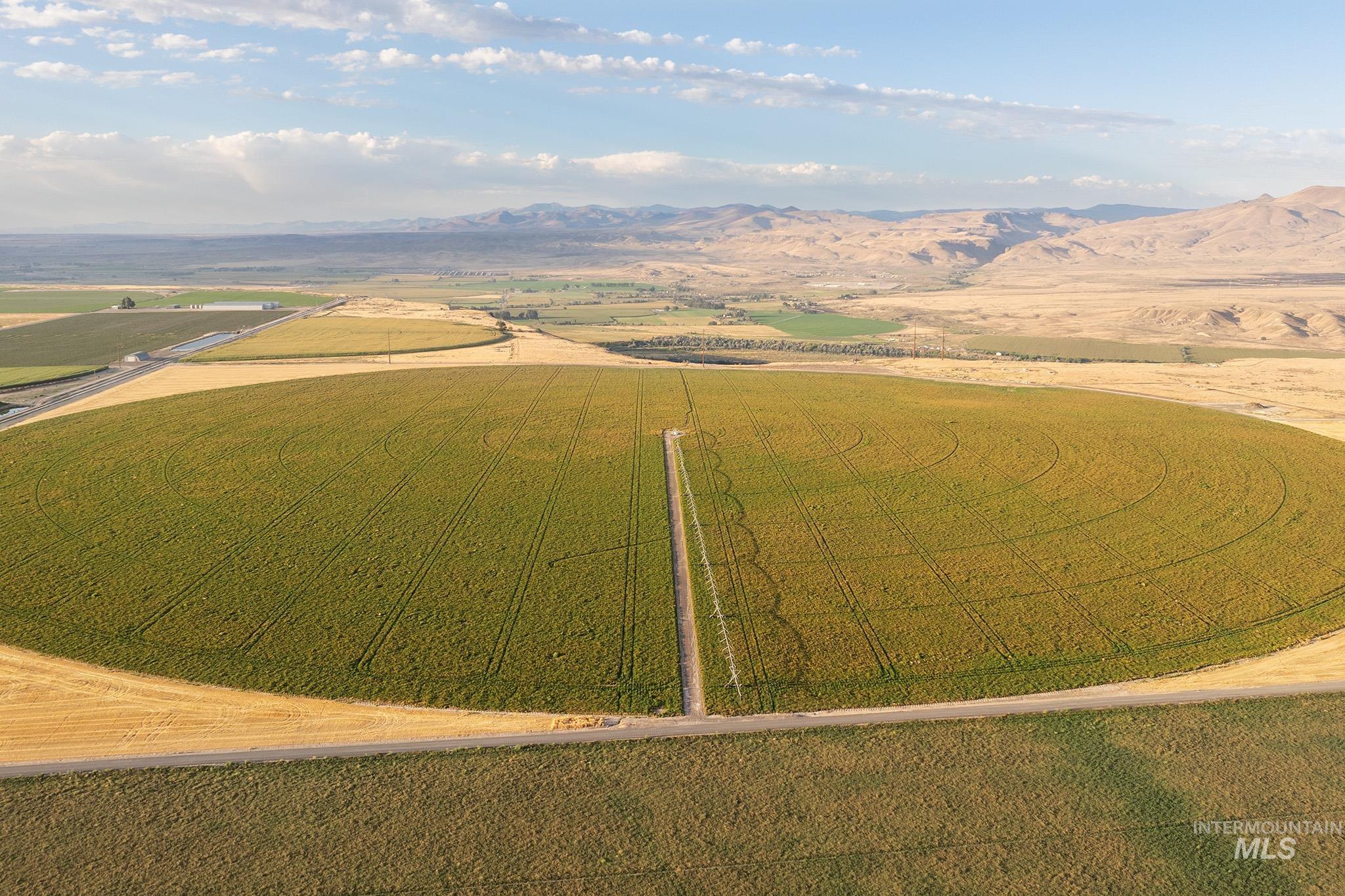 Aerial view of sparsely populated area featuring mountains and extensive farmland