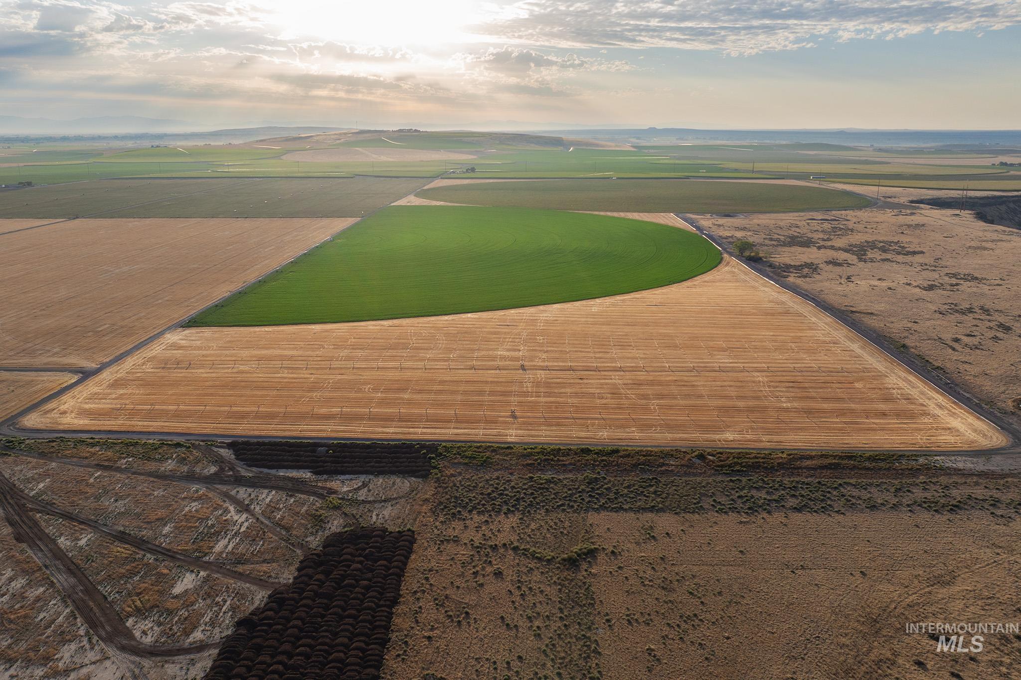 Aerial view of property's location featuring rural landscape and extensive farmland