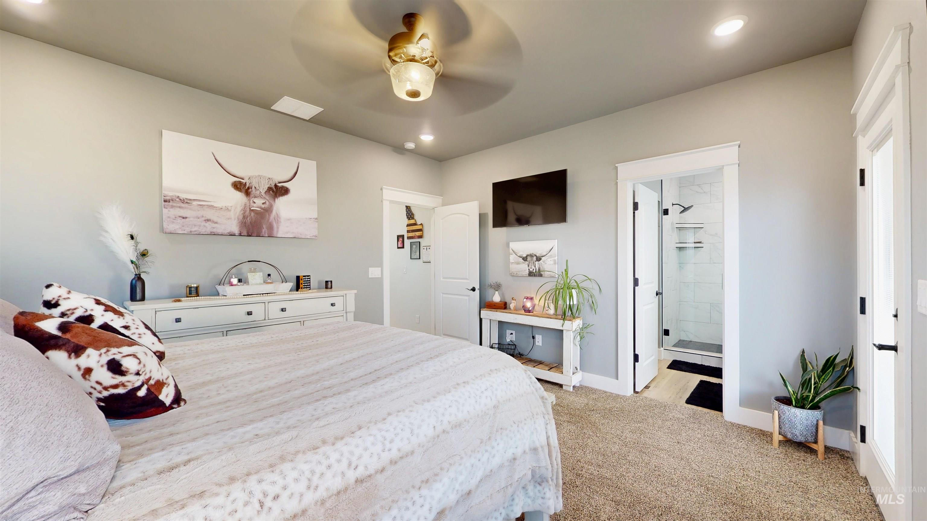 Bedroom with light carpet, recessed lighting, ceiling fan, and ensuite bathroom