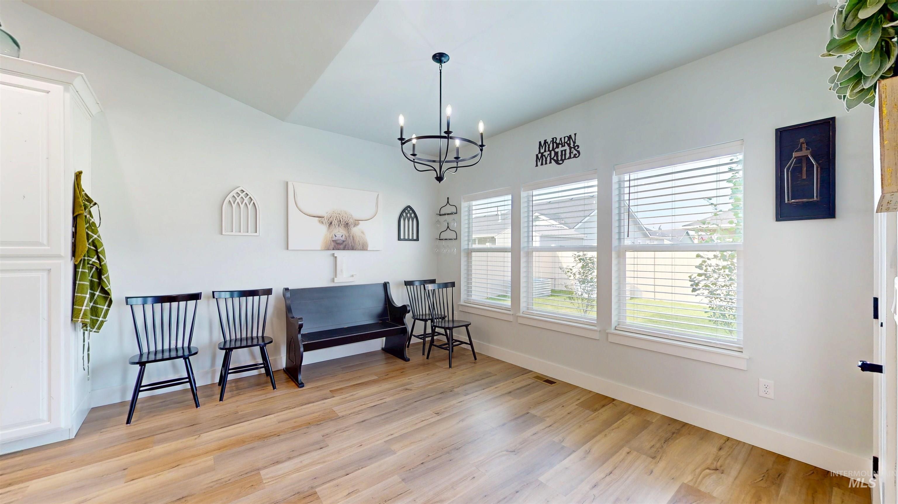 Living area with light wood finished floors and a chandelier