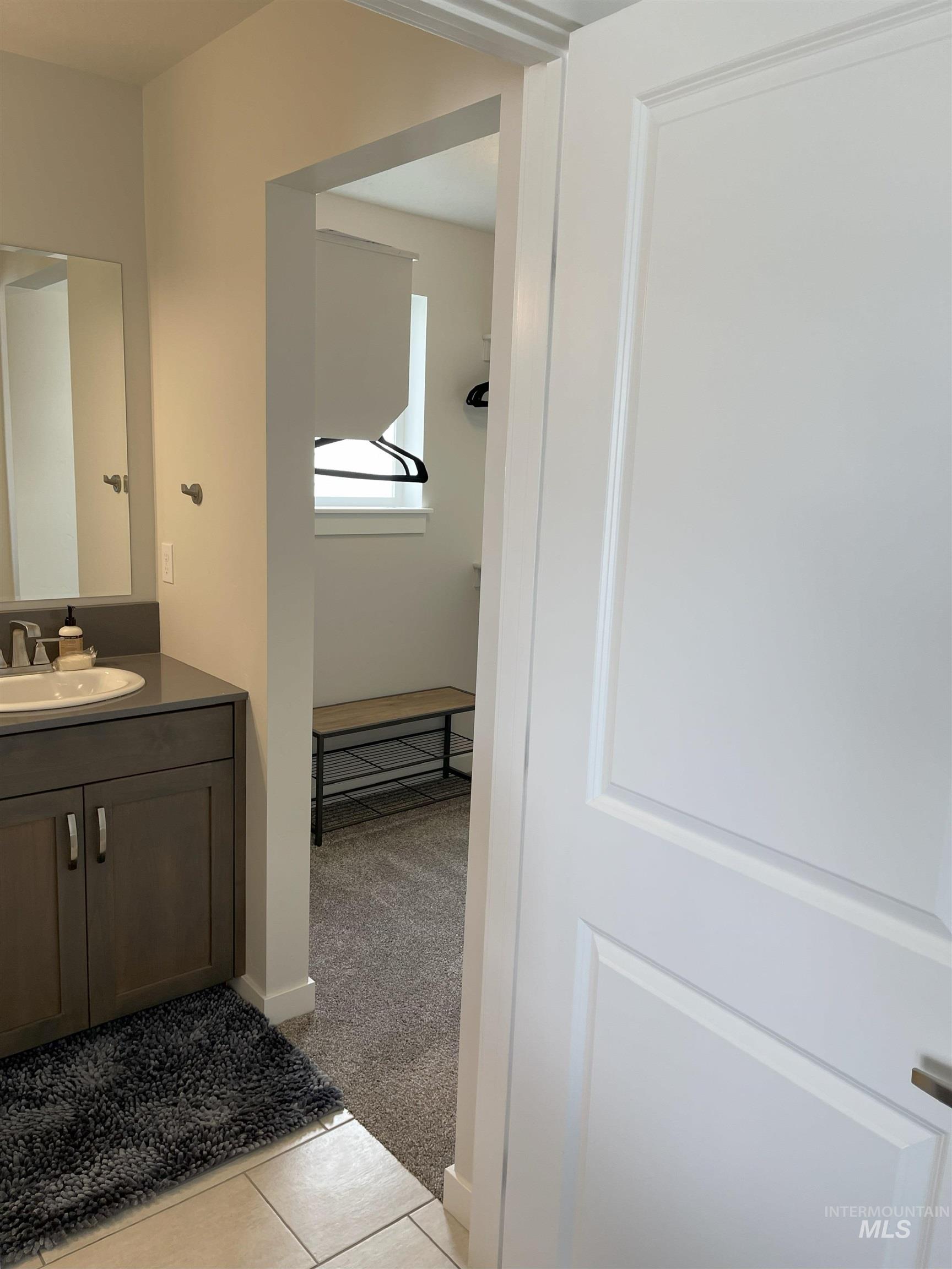 Bathroom with vanity and light tile patterned flooring