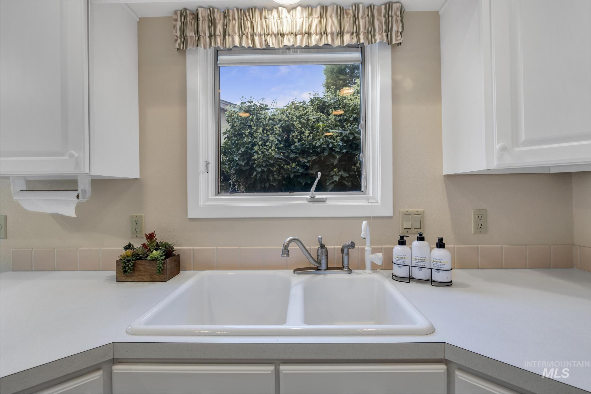 Kitchen with light countertops and white cabinets