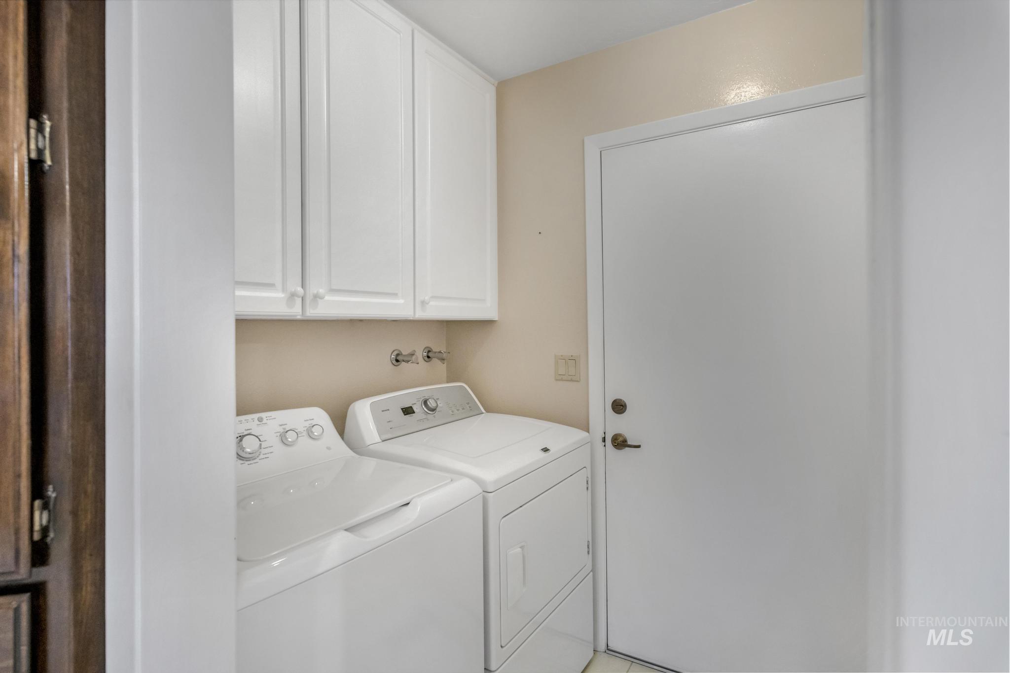 Laundry room with cabinet space and washer and dryer
