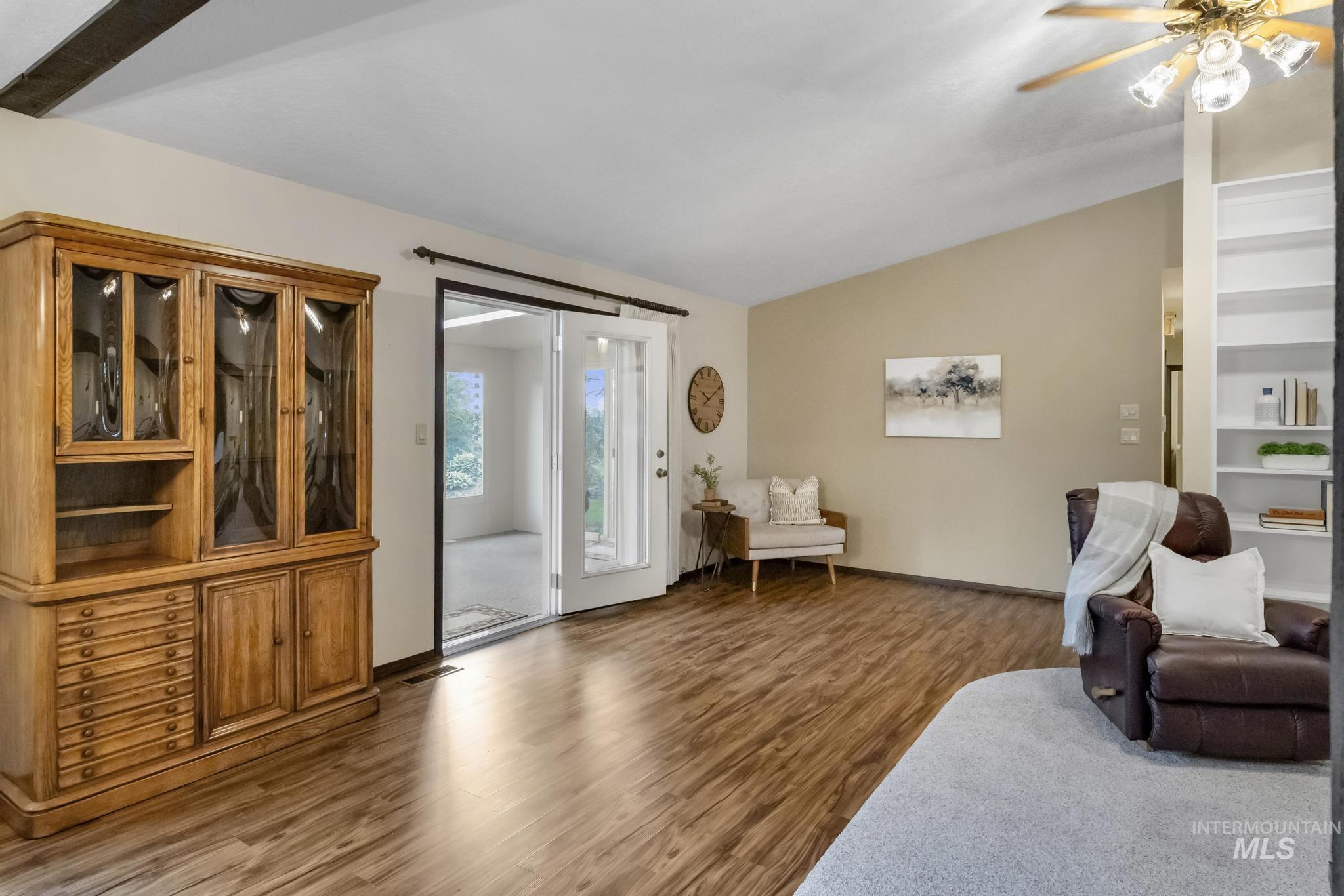 Sitting room featuring wood finished floors, lofted ceiling, and ceiling fan