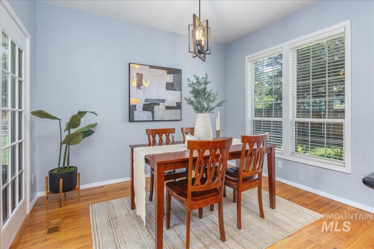 Dining room featuring light wood finished floors and a chandelier