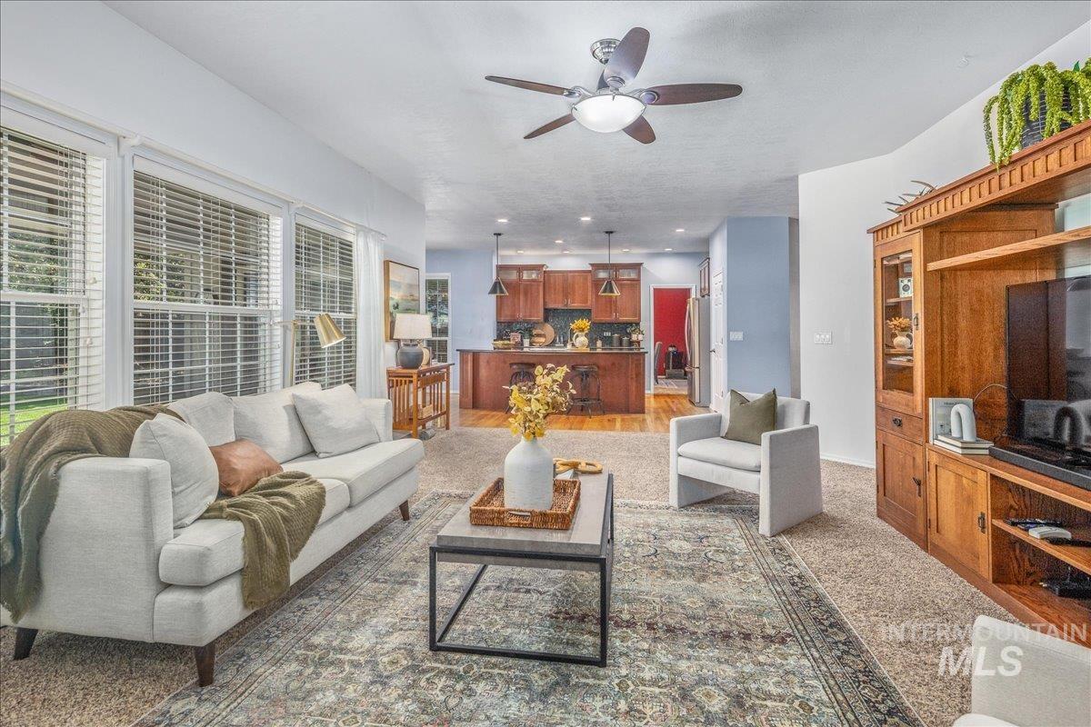 Living area with a ceiling fan and plenty of natural light